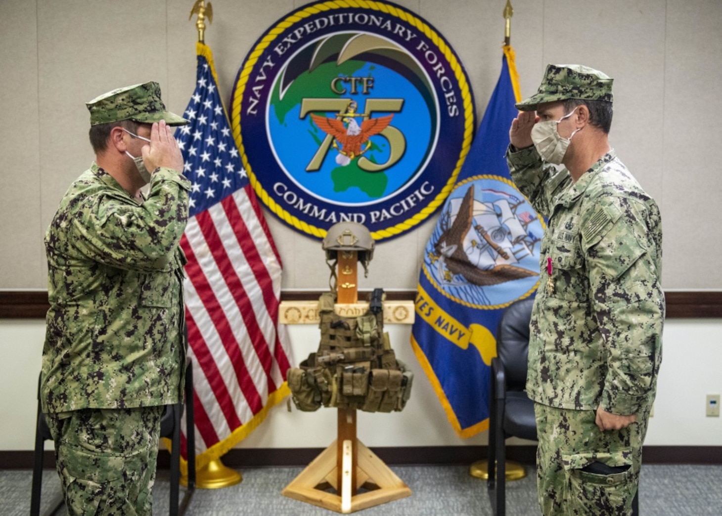 SANTA RITA, Guam (Oct. 2, 2020) Capt. Eric Correll, right, salutes Capt. Gareth Healy, as he is properly relieved of command of Navy Expeditionary Forces Command Pacific-Task Force (CTF) 75 during a change of command ceremony held at the headquarters building in Camp Covington on Naval Base Guam. CTF 75 is 7th Fleet's primary expeditionary task force and is responsible for the planning and execution of maritime security operations, explosive ordnance disposal, diving, engineering and construction, and underwater construction. It additionally provides direct support to diving and salvage operations and expeditionary intelligence throughout the Indo-Asia-Pacific region.