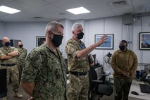 200929-N-KZ419-1060 NAVAL SUPPORT ACTIVITY BAHRAIN (Sept. 29, 2020) - Royal Navy Cmdr. Graeme Smith, middle, briefs the capabilities of Coalition Task Force Sentinel, the operational arm of the International Maritime Security Construct (IMSC), to Vice Adm. Samuel Paparo, commander of U.S. Naval Forces Central Command, U.S. 5th Fleet and Combined Maritime Forces, on board Naval Support Activity Bahrain, Sept. 29. IMSC is a multinational maritime effort to promote maritime stability, ensure safe passage, and enhance freedom of navigation throughout key waterways in the Arabian Gulf, Strait of Hormuz, the Bab el-Mandeb Strait and the Gulf of Oman. (U.S. Navy photo by Mass Communication Specialist 3rd Class Dawson Roth)