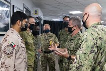 200929-N-KZ419-1104 NAVAL SUPPORT ACTIVITY BAHRAIN (Sept. 29, 2020) - Vice Adm. Samuel Paparo, second from right, commander of U.S. Naval Forces Central Command, U.S. 5th Fleet and Combined Maritime Forces, speaks with members of Coalition Task Force Sentinel, the operational arm of the International Maritime Security Construct (IMSC), at the IMSC headquarters on board Naval Support Activity Bahrain, Sept. 29. IMSC is a multinational maritime effort to promote maritime stability, ensure safe passage, and enhance freedom of navigation throughout key waterways in the Arabian Gulf, Strait of Hormuz, the Bab el-Mandeb Strait and the Gulf of Oman. (U.S. Navy photo by Mass Communication Specialist 3rd Class Dawson Roth)
