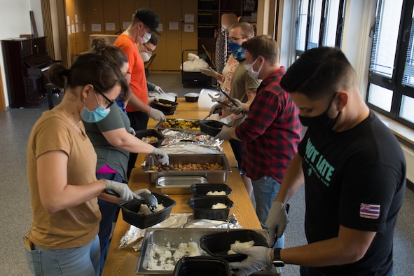 Photograph of volunteers putting meals together.