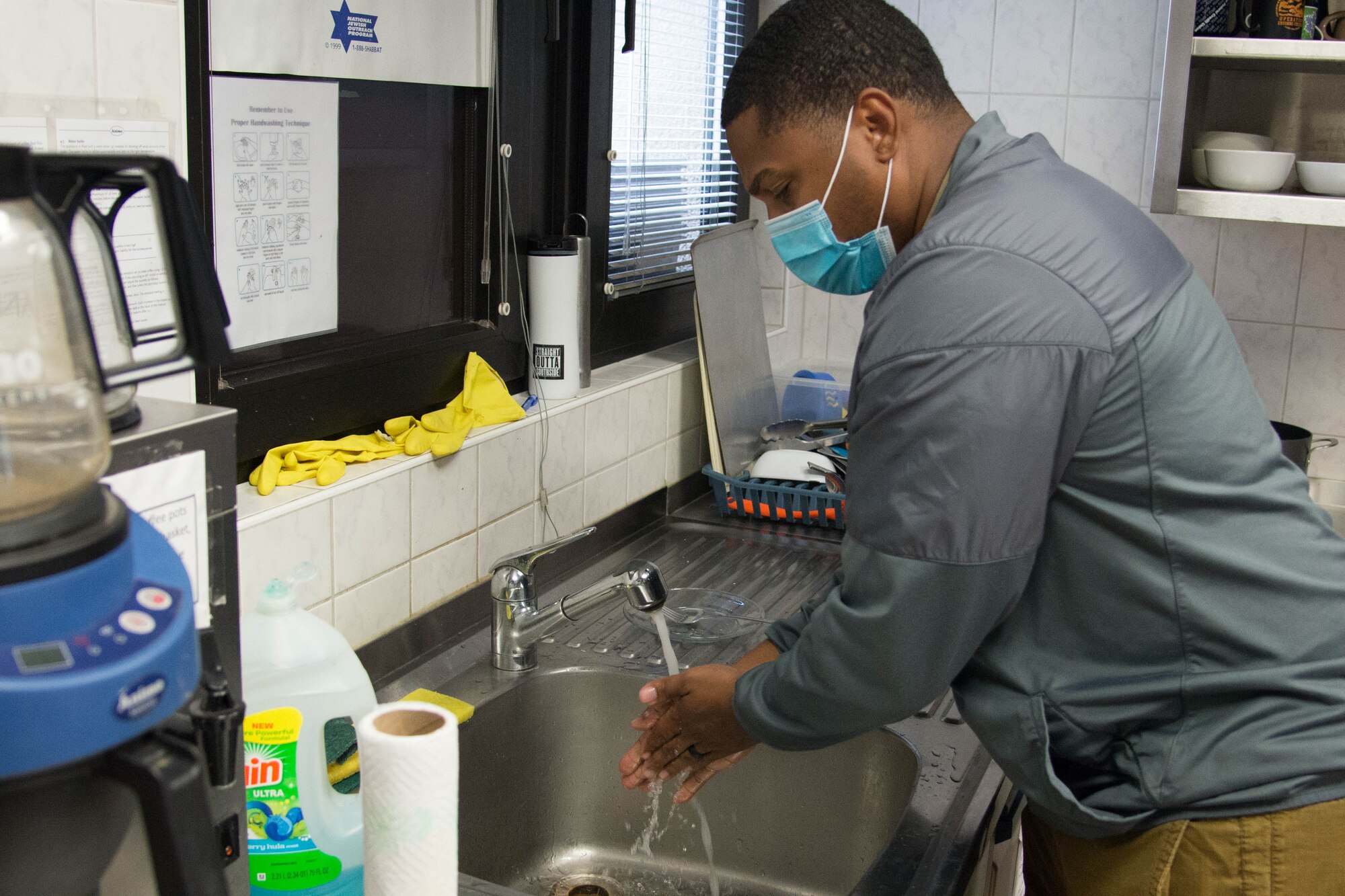 Photograph of volunteer washing his hands.