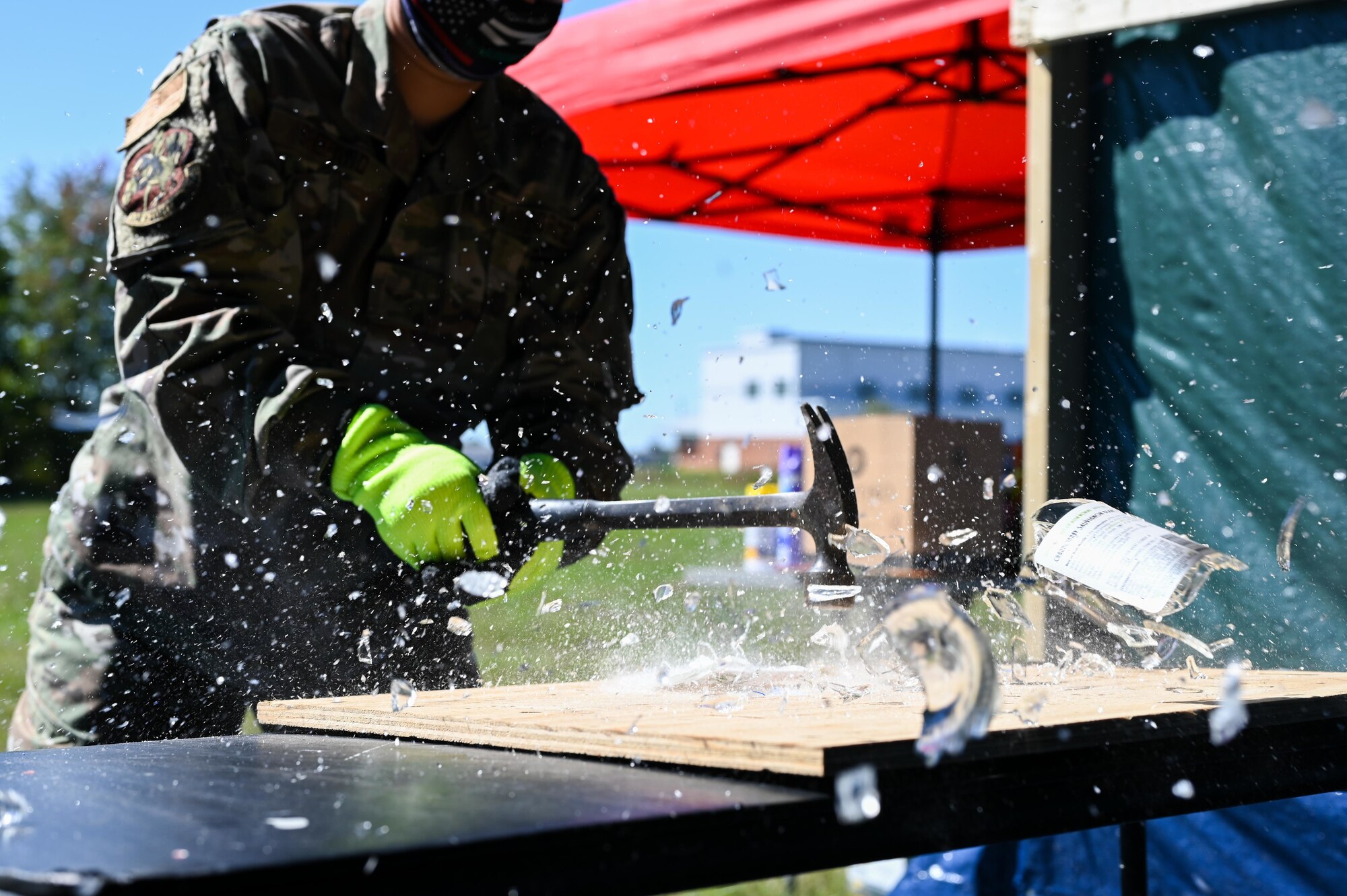 An Airmen from the 175th Wing hits a glass bottle with a hammer Oct. 3, 2020, during a “Therapy Breaking” event Oct. 3, 2020, at Warfield Air National Guard Base, Middle River, Md. This event was part of the third annual Wellness Week where activities were organized to promote wellness and decrease stress. (U.S. Air National Guard photo by Senior Airman Sarah M. McClanahan)