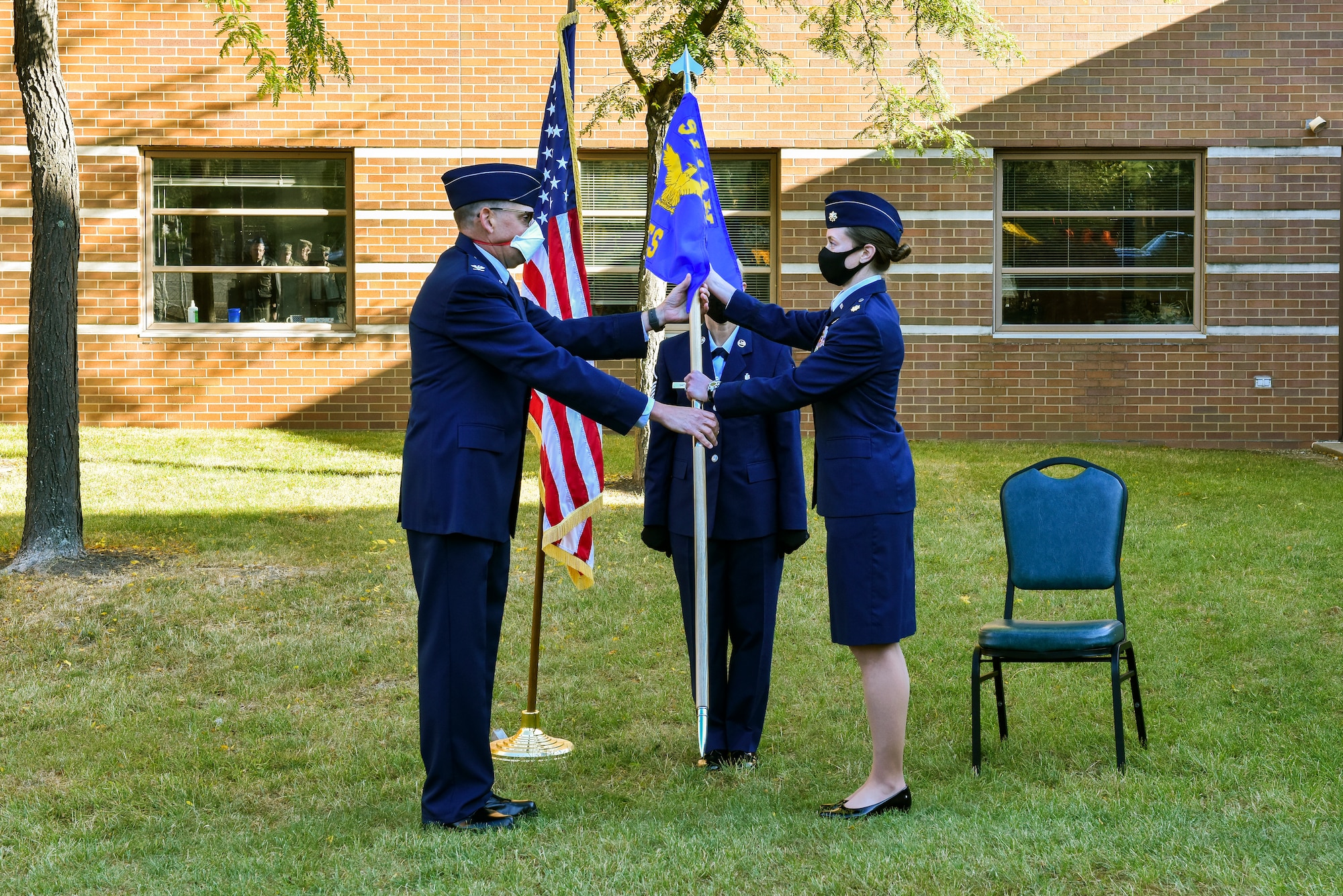 Col. Kenneth M. Lute, commander of the 911th Mission Support Group, passes the guidon to Maj. Corey L. Chance, commander of the 911th Civil Engineering Squadron at the Pittsburgh International Airport Air Reserve Station, Pennsylvania, Oct. 3, 2020.