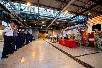 Firefighters and Airmen from the 423rd Air Base Group listen to a speech by David Herman, center, 423rd Civil Engineer Squadron assistant chief of fire prevention, at RAF Alconbury, England, Oct. 5, 2020. U.S. Air Force Col. Richard Martin, 423rd ABG commander, proclaimed Oct. 5-9 as Fire Prevention week, which is designed to honor the sacrifices of our firefighters and teach fire safety to others. (U.S. Air Force photo by Senior Airman Eugene Oliver
