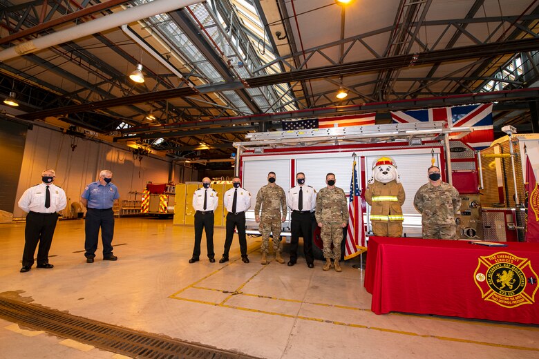 Firefighters and Airmen from the 423rd Air Base group, pose for a photo at RAF Alconbury, England, Oct. 5, 2020. U.S. Air Force Col. Richard Martin, 423rd ABG commander, proclaimed Oct. 5-9 as Fire Prevention week, which is designed to honor the sacrifices of our firefighters and teach fire safety to others. (U.S. Air Force photo by Senior Airman Eugene Oliver)
