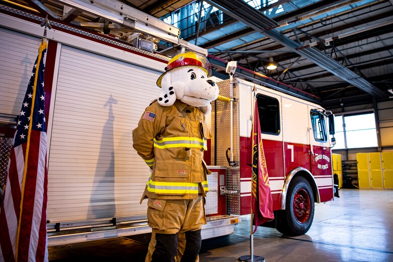 Sparky, 423rd Air Base Group mascot, stands at attention during a fire proclamation signing at RAF Alconbury, England, Oct. 5, 2020. U.S. Air Force Col. Richard Martin, 423rd ABG commander, proclaimed Oct.5-9 as Fire Prevention week, which is designed to honor the sacrifices of our firefighters and teach fire safety to others. (U.S. Air Force photo by Senior Airman Eugene Oliver)