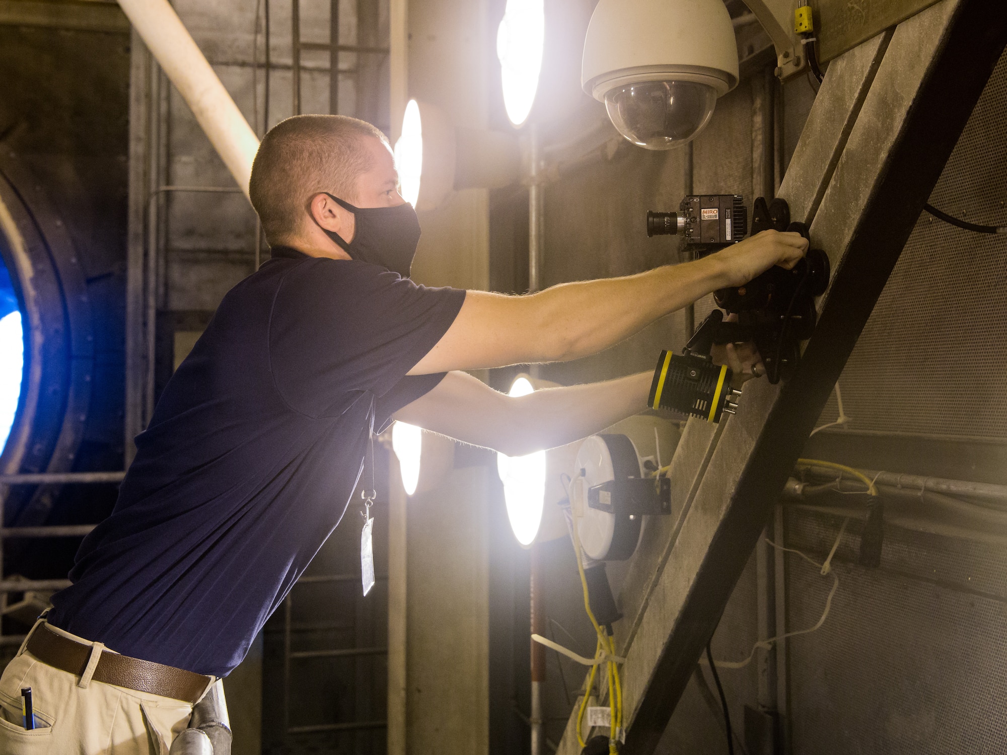 Seth Beaman, a Naval Air Systems Command aeropropulsion test analyst, sets up a high-speed camera, Sept. 1, 2020, in the sea-level test cell SL-1 at Arnold Air Force Base, Tenn. The camera, combined with software, allows for the observation and measurement of vibrations. Beaman is studying the potential for its use as an analysis tool for engine testing. (U.S. Air Force photo by Jill Pickett)