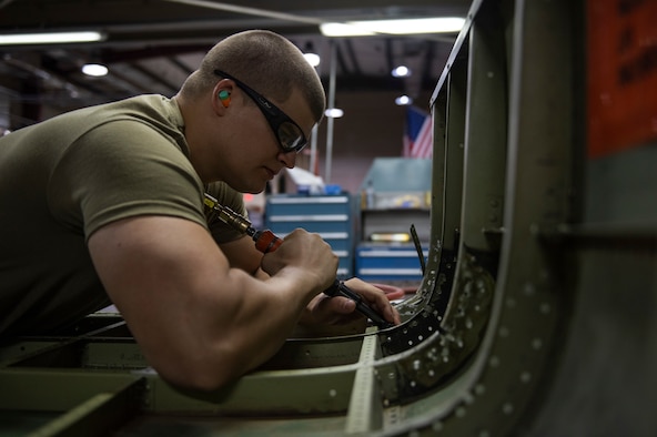 Staff Sgt. Nicholas Novotney uses a 90-degree terry drill on a helicopter door