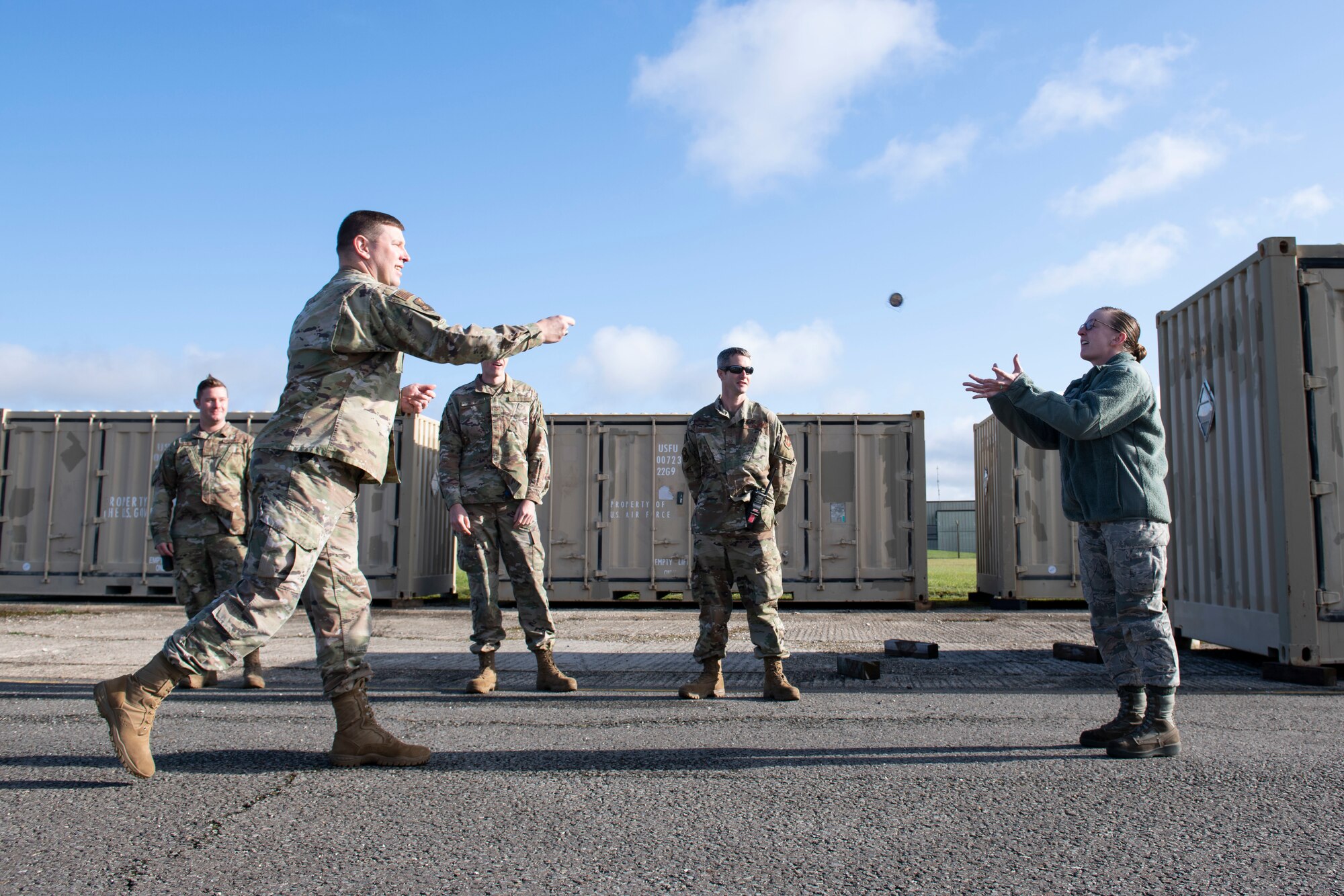 U.S. Air Force Staff Sgt. Candace Mendoza, right, 420th Munitions Squadron inspection production supervisor, receives a coin of excellence from Col. Kurt Wendt, left, 501st Combat Support Wing commander, during a visit to RAF Welford, England, Oct. 1, 2020. Wendt visited 420th MUNS to meet with the Airmen and to learn more about their new mission capabilities. (U.S. Air Force photo by Senior Airman Jennifer Zima)