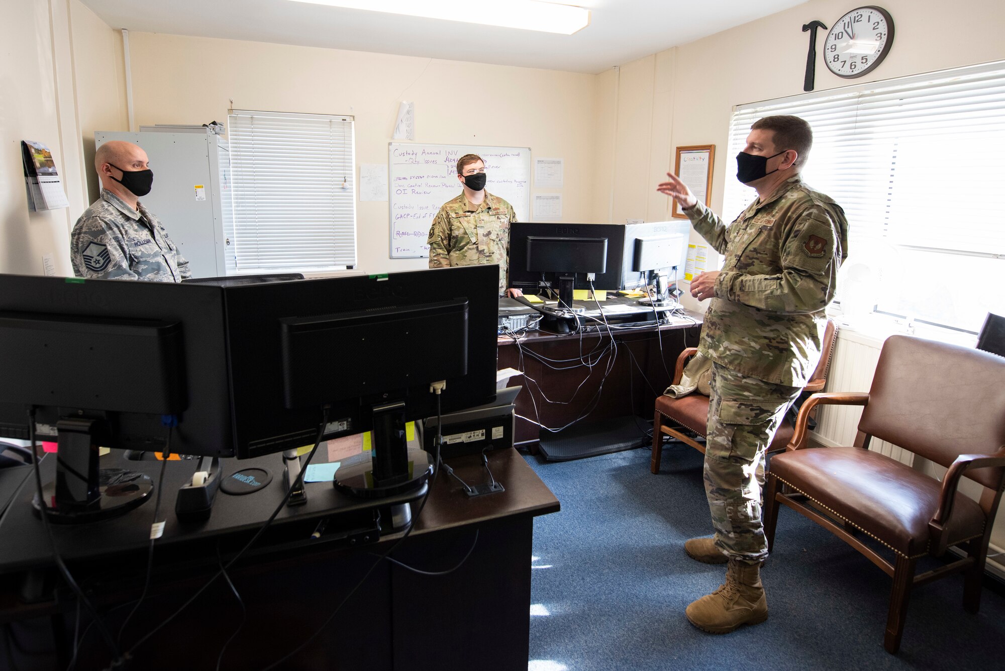 U.S. Air Force Col. Kurt Wendt, right, 501st Combat Support Wing commander, speaks with Master Sgt. Jonathan Holleman, left, 420th Munitions Squadron munitions accountable systems officer, and Tech. Sgt. Jacob Hillyer, center, 420th MUNS noncommissioned officer in charge of munitions operations, about the new munitions stockpile inventory system, the Theater Integrated Combat Munitions Systems (TICMS), during a visit to RAF Welford, England, Oct. 1, 2020. Wendt visited 420th MUNS to meet with the Airmen and to learn more about their new mission capabilities. (U.S. Air Force photo by Senior Airman Jennifer Zima)