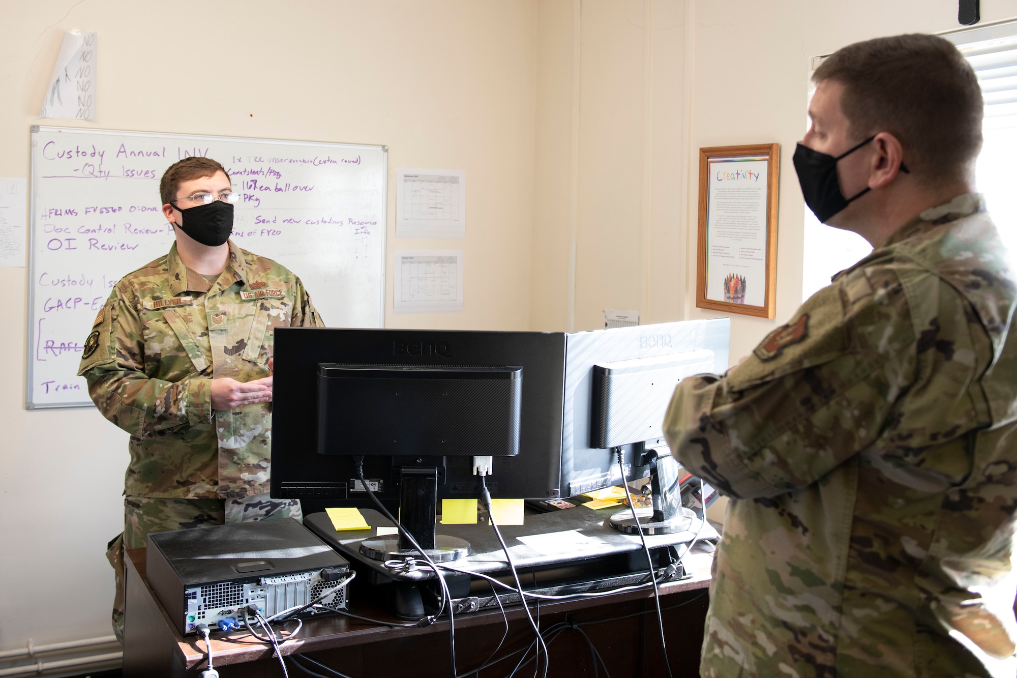 U.S. Air Force Tech. Sgt. Jacob Hillyer, left, 420th MUNS noncommissioned officer in charge of munitions operations, shares with Col. Kurt Wendt, right, 501st Combat Support Wing commander, information about the new munitions stockpile inventory system, the Theater Integrated Combat Munitions Systems (TICMS), during a visit to RAF Welford, England, Oct. 1, 2020. Wendt visited 420th MUNS to meet with the Airmen and to learn more about their new mission capabilities. (U.S. Air Force photo by Senior Airman Jennifer Zima)