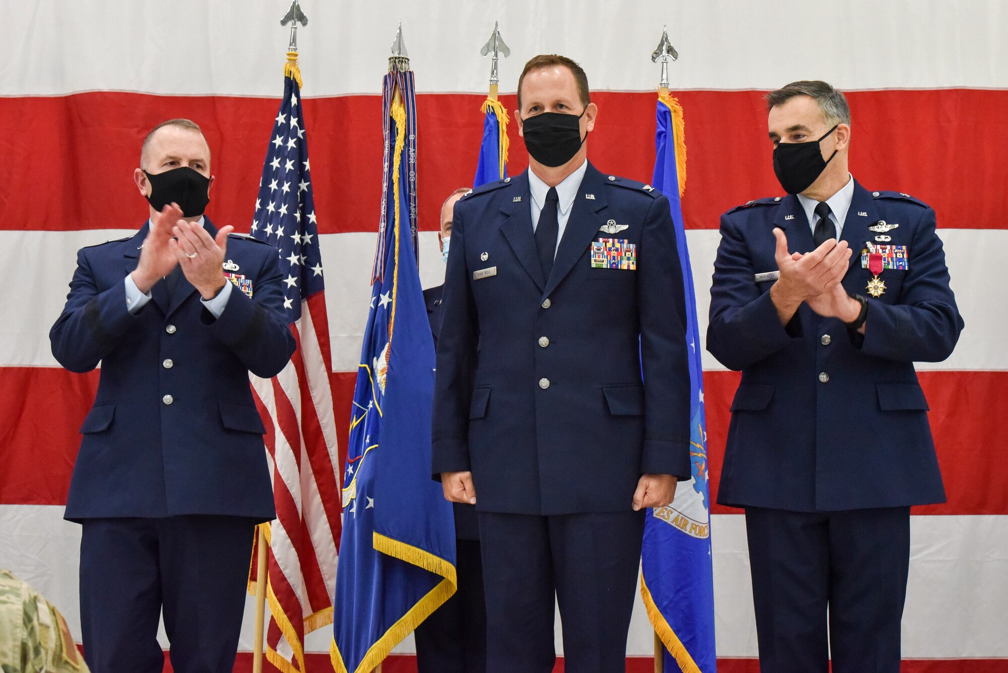 Brig. Gen. David May, Wisconsin’s deputy adjutant general for Air and Brig. Gen. Erik Peterson, Chief of Staff, Wisconsin Air National Guard, applaud Col. Bart Van Roo, 115th Fighter Wing commander, for his assumption of command as part of the official change of command ceremony in an aircraft hangar at the 115th Fighter Wing, Madison, Wis., Oct 3, 2020. Col. Bart Van Roo assumed command of the 115th Fighter Wing from Brig. Gen. Erik Peterson. (U.S. Air National Guard Photo by Tech. Sgt. Mary Greenwood)