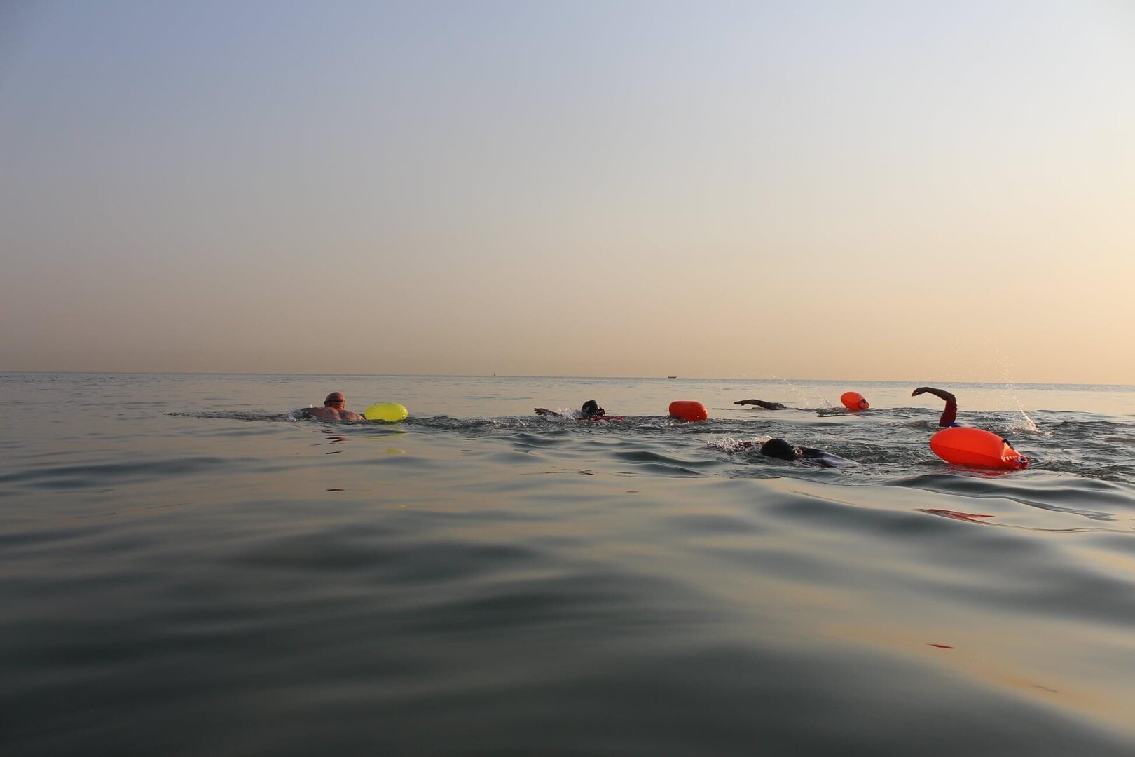 Eric Reich, left, Defense Logistics Agency Disposition Services’ operations supervisor and site lead at Camp Arifjan, leads the way against 30 competitors during a Sept. 18 one kilometer open water swim in the Persian Gulf at Abu Halifa Beach.