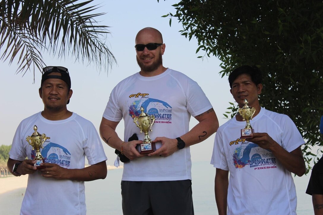 Eric Reich, center, Defense Logistics Agency Disposition Services’ operations supervisor and site lead at Camp Arifjan in Kuwait, accepts his first place award with Ernel Carino, left, the second place finisher, and Raymondo Gambol, who took third in the Sept. 18 event.