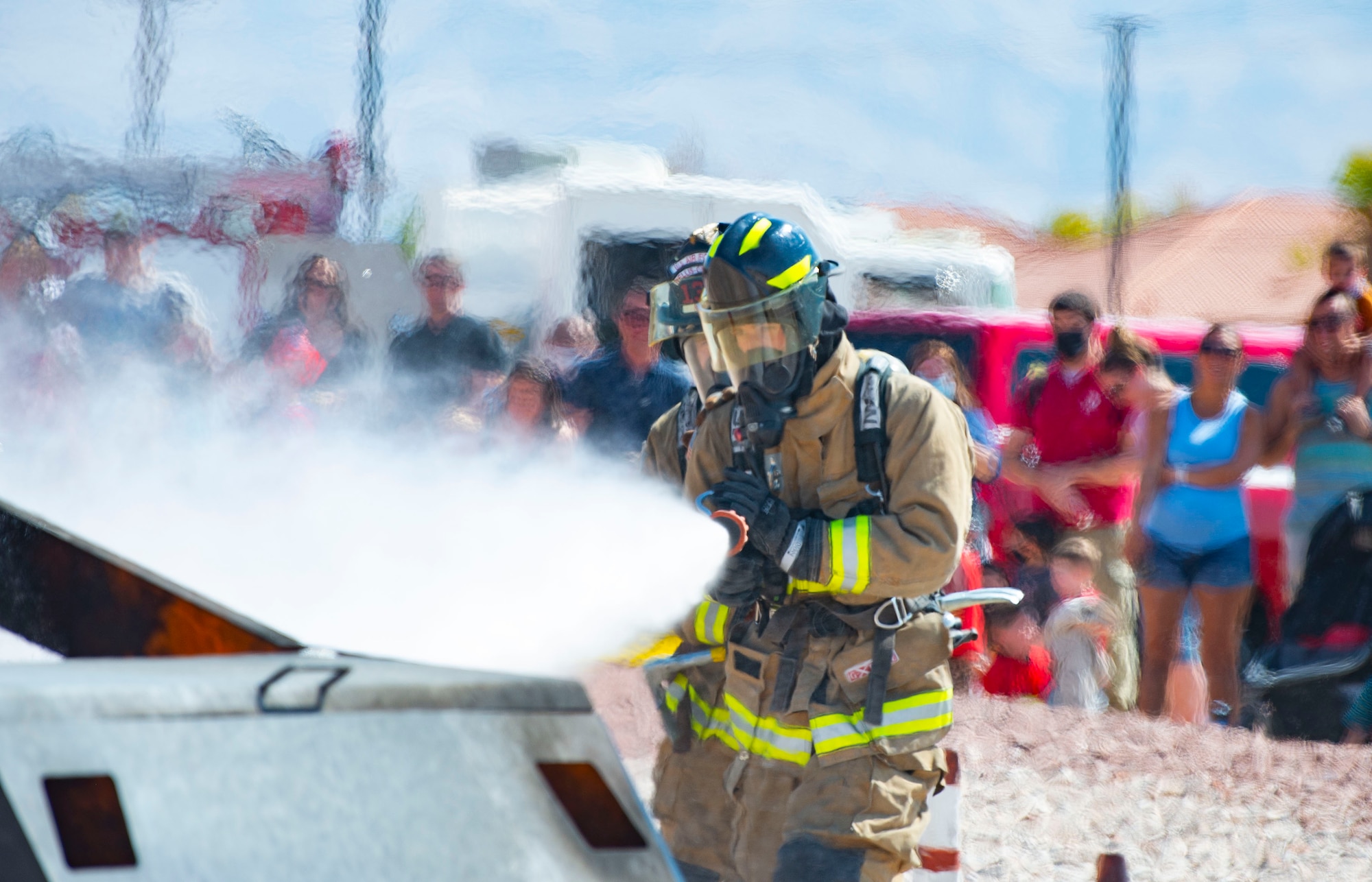 Firefighters extinguish car fire during demonstration.