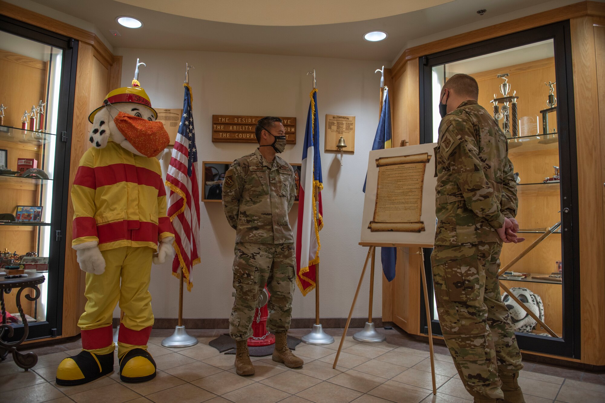 Staff Sgt. Jordan Elkins, 7th Civil Engineer Squadron fire inspector, right, reads a Fire Prevention Week proclamation to Col. Ed Sumangil, 7th Bomb Wing commander, at Dyess Air Force Base, Texas, Oct. 5, 2020. Sumangil declared that the week will be dedicated to bringing awareness to common household fire hazards while educating the community of standard fire safety and prevention.  (U.S. Air Force photo by Airman 1st Class Colin Hollowell)