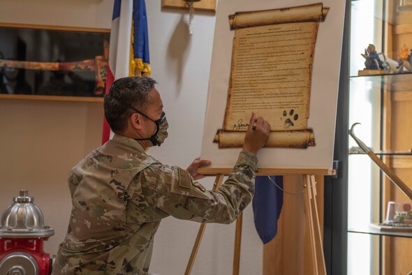 Staff Sgt. Jordan Elkins, 7th Civil Engineer Squadron fire inspector, right, reads a Fire Prevention Week proclamation to Col. Ed Sumangil, 7th Bomb Wing commander, at Dyess Air Force Base, Texas, Oct. 5, 2020. Sumangil declared that the week will be dedicated to bringing awareness to common household fire hazards while educating the community of standard fire safety and prevention.  (U.S. Air Force photo by Airman 1st Class Colin Hollowell)
