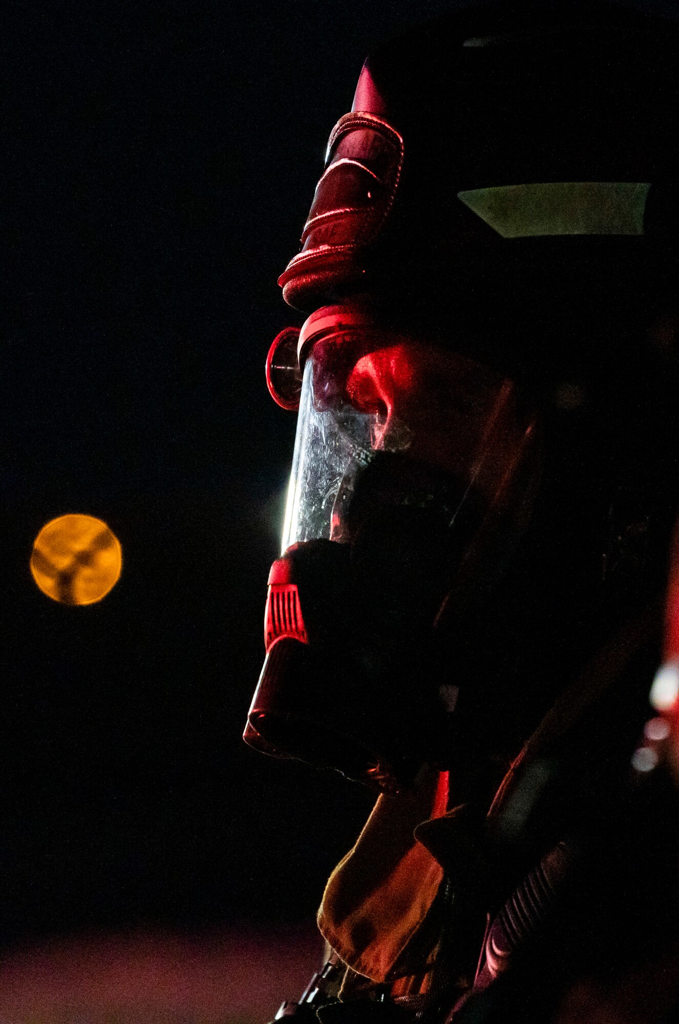 A firefighter from the 436th Civil Engineer Squadron watches a live-fire-burn exercise at night Sept. 28, 2020, on Dover Air Force Base, Delaware. Total Force and civilian fire companies in the surrounding community often partner with Dover AFB to complete annual training requirements. (U.S. Air Force photo by Senior Airman Christopher Quail)