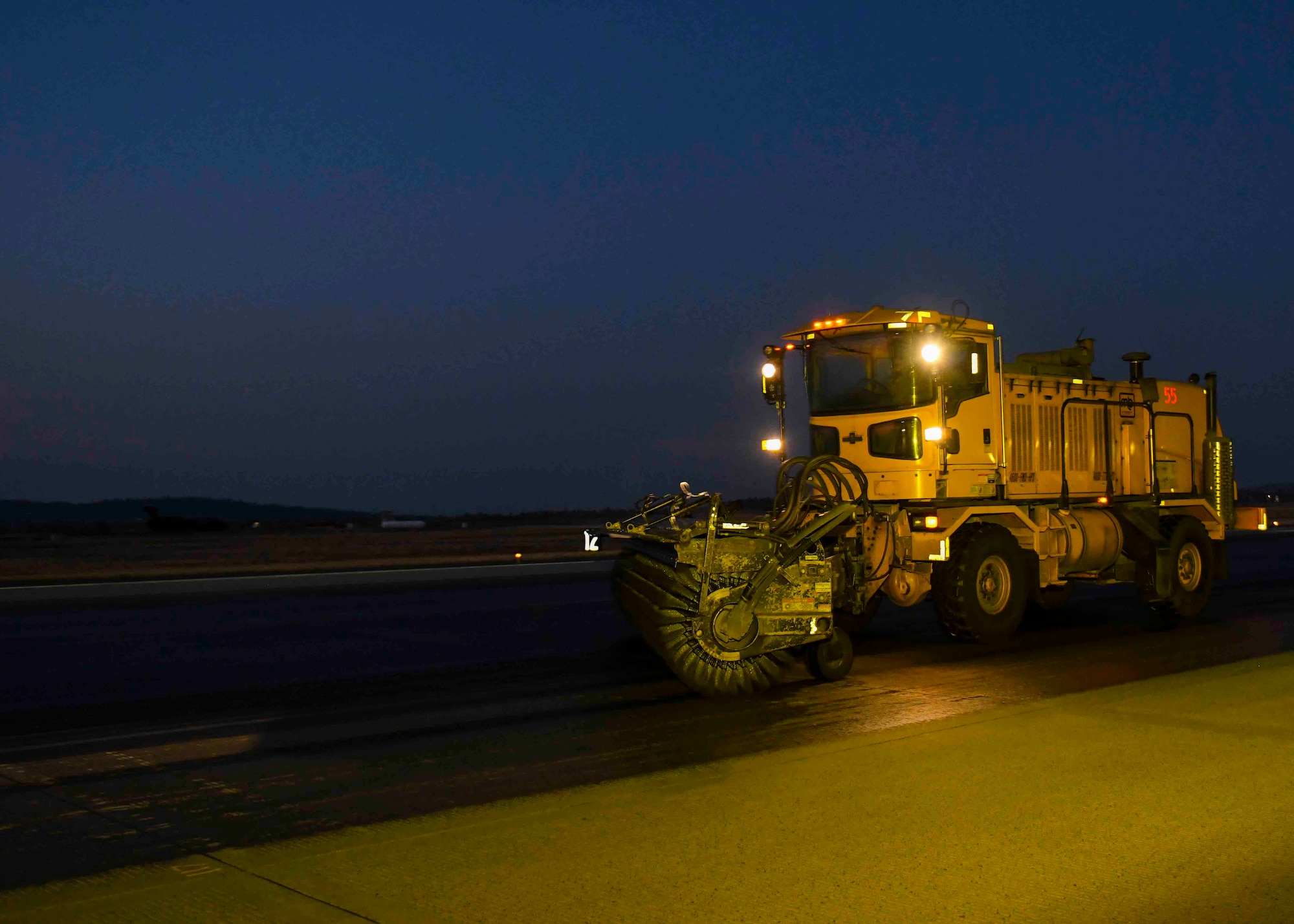 A 92nd Civil Engineering Squadron Airman operates heavy snow removal equipment to scrub the flightline as part of flightline rubber removal at Fairchild Air Force Base, Washington, Oct, 3, 2020. 92nd CES Airmen train on the flightline using the snow removal equipment during rubber removal to prepare for upcoming winter weather. (U.S. Air Force photo by Airman 1st Class Kiaundra Miller)_