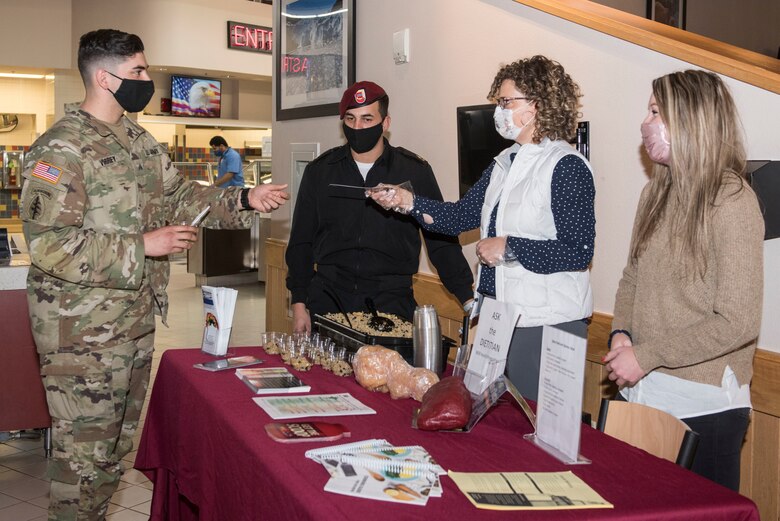A U.S. Army soldier receives a pamphlet on nutritional food choices during the 'Ask the Registered Dietitian' Nutrition and Taste Testing event at Joint Base Elmendorf-Richardson, Alaska, Sept. 29, 2020. The event was held to educate service members about how food and nutrition effect military readiness, while also offering samples of healthier choices to service members.