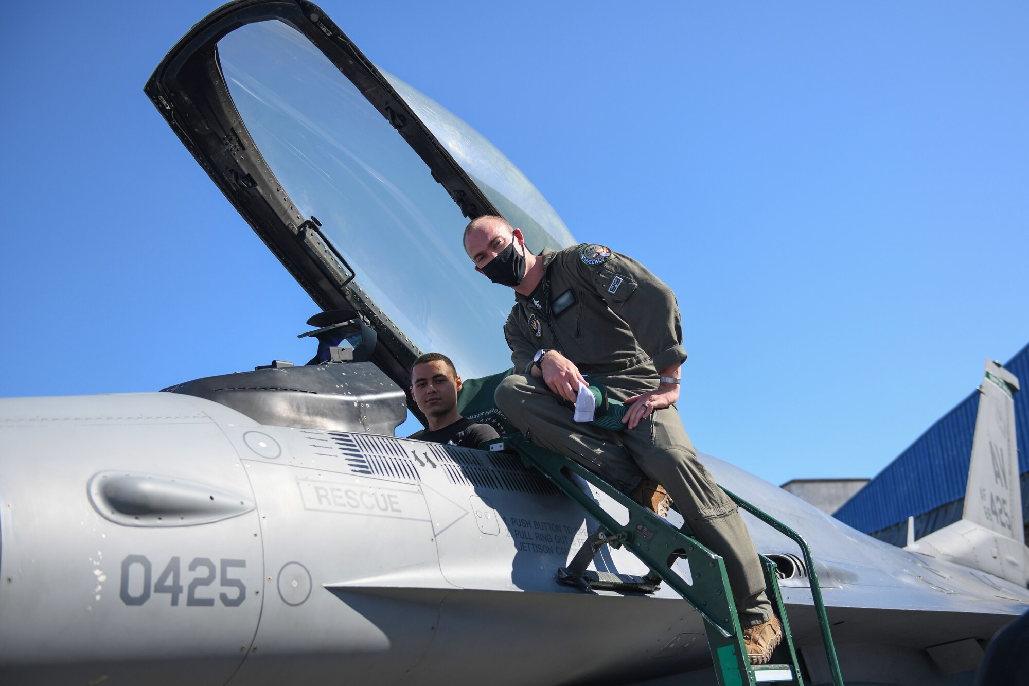 A U.S. Air Force pilot from the 555th Fighter Squadron, Aviano Air Base, Italy, and a student from First English Language School, Sofia, Bulgaria, pose for a photo, Oct. 2, 2020, at Graf Ignatievo Air Base, Bulgaria. The students met with both a pilot and a crew chief for about 25 minutes and discussed the various parts of a U.S. Air Force F-16 Fighting Falcon. During their visit, the students had the opportunity to practice the English language while discussing the various parts of the aircraft. (U.S. Air Force photo by Airman 1st Class Ericka A. Woolever)