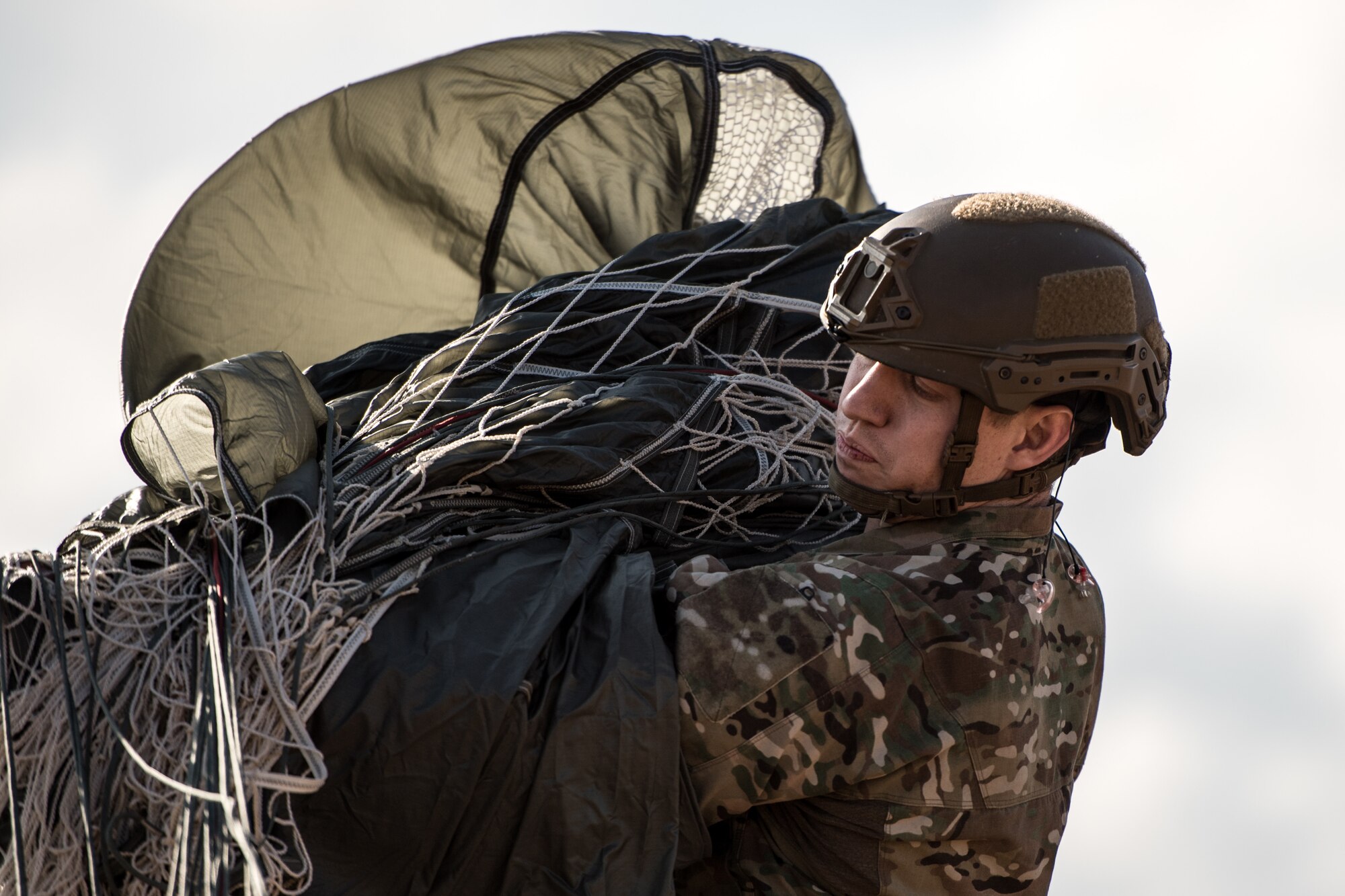 Photo of Airman packing a used parachute