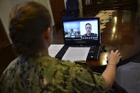 SINGAPORE (Oct. 5, 2020) – Capt. Ann McCann, commodore of Destroyer Squadron 7, listens to opening remarks during a virtual opening ceremony for Cooperation Afloat Readiness and Training (CARAT) Brunei 2020. 2020 marks the 26th iteration of CARAT, a multinational exercise designed to enhance U.S. and partner navies' abilities to operate together in response to traditional and non-traditional maritime security challenges in the Indo-Pacific region.