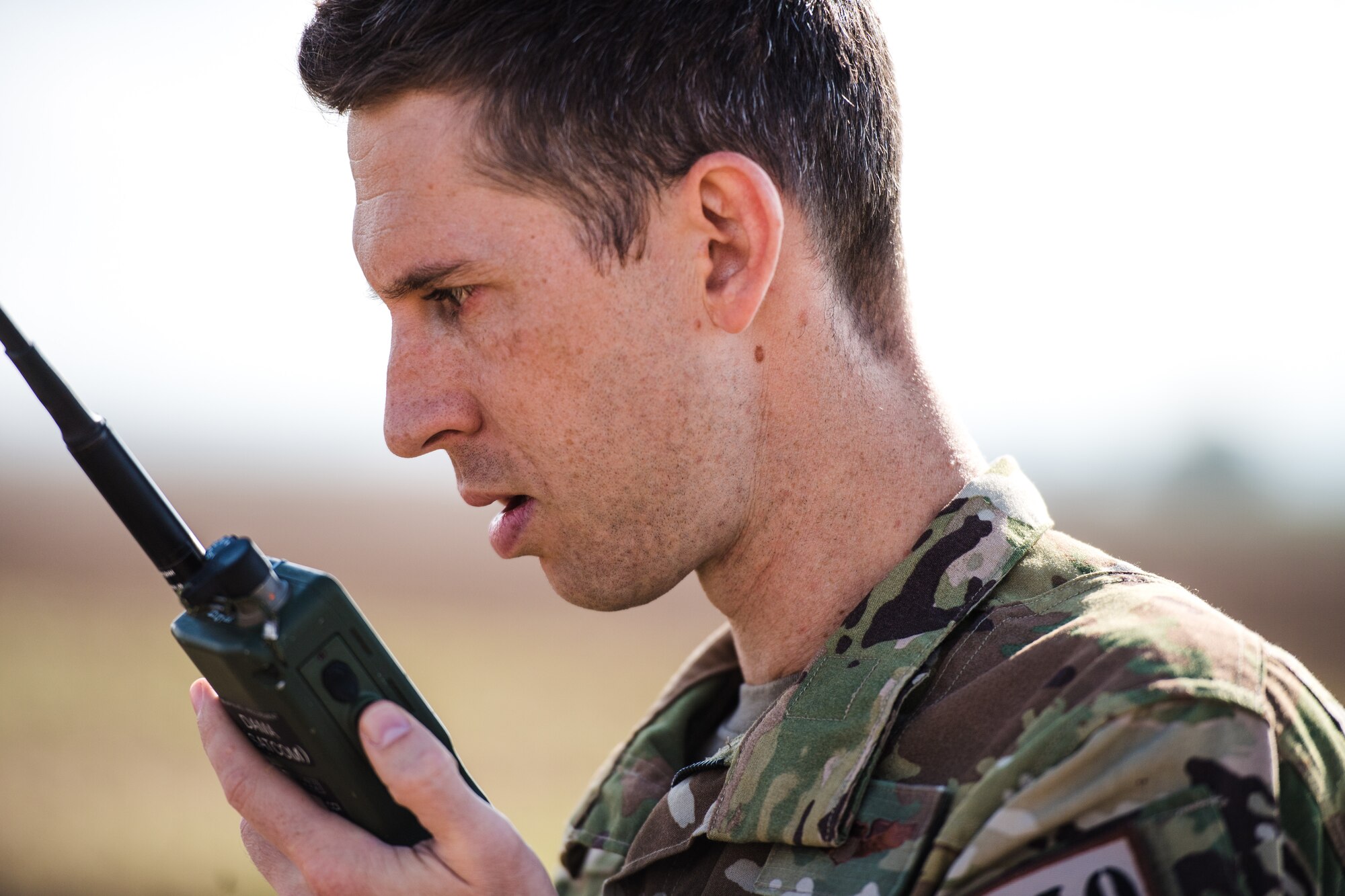 Photo of Airman talking with a radio