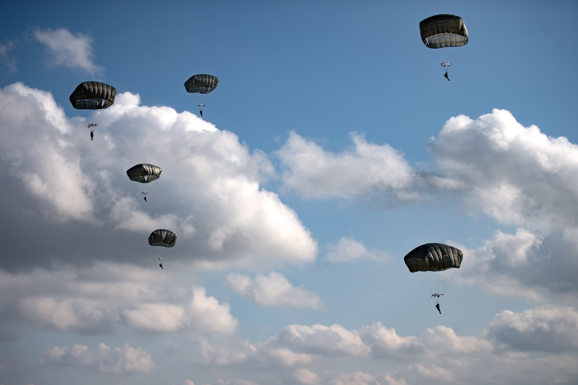 Photo of Airmen descending with parachutes