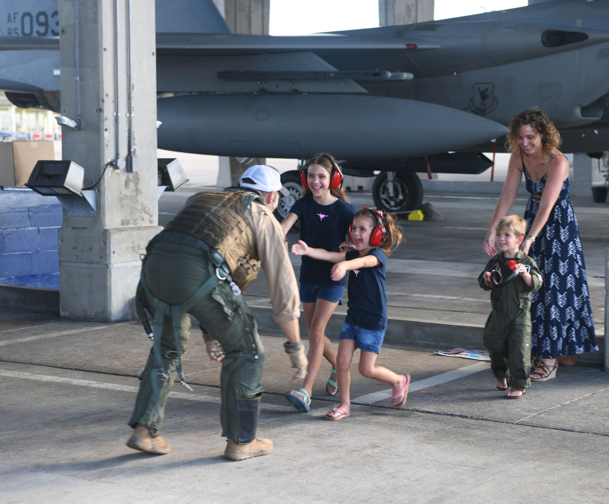 U.S. Air Force Maj. Jonathan Taylor, 44th Fighter Squadron assistant director of operations, is welcomed back from a deployment by his family Oct. 3, 2020, at Kadena Air Base, Japan. While deployed to the U.S. Central Command area of operations, Airmen conducted more than 1,000 sorties and 5,300 combat hours, which drove 13 phase inspections in six months. They’ll now share the skills they learned in combat with Team Kadena, joint partners and allies to ensure a free and open Indo-Pacific. (U.S. Air Force photo by Tech. Sgt. Benjamin Sutton)