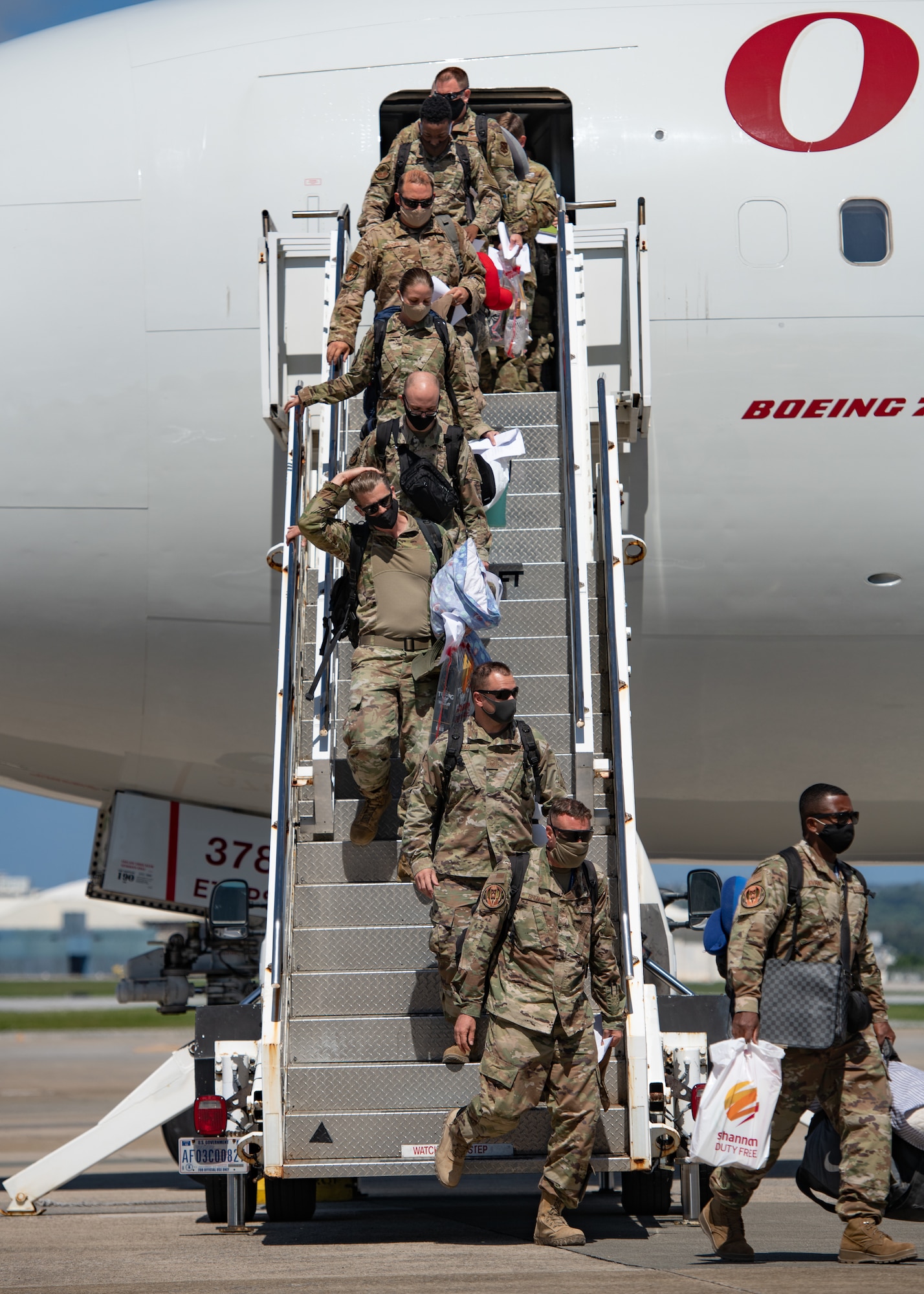 Airmen from the 18th Wing disembark an aircraft upon their return from a deployment to U.S. Central Command Oct. 6, 2020, at Kadena Air Base, Japan. More than 300 Airmen assigned to the 18th Operations and Maintenance Groups as well as pilots and aircraft assigned to the 44th Fighter Squadron deployed to the CENTCOM theater to defend U.S. and partner nation interests. During their deployment, Airmen conducted more than 1,000 sorties and 5,300 combat hours, which drove 13 phase inspections in six months. They’ll share the skills they learned in combat with Team Kadena, joint partners and allies to ensure a free and open Indo-Pacific. (U.S. Air Force photo by Staff Sgt. Peter Reft)