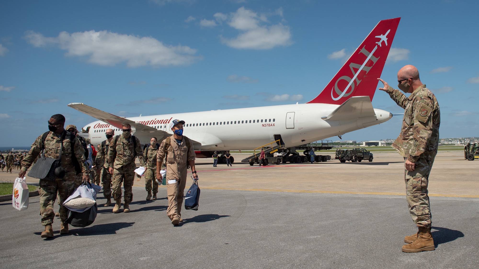 U.S. Air Force Brig. Gen. Joel L. Carey, 18th Wing commander, greets members who return from a deployment to U.S. Central Command Oct. 6, 2020, at Kadena Air Base, Japan. While deployed to the CENTCOM area of operations, Airmen conducted more than 1,000 sorties and 5,300 combat hours, which drove 13 phase inspections in six months. They’ll share the skills they learned in combat with Team Kadena, joint partners and allies to ensure a free and open Indo-Pacific. (U.S. Air Force photo by Staff Sgt. Peter Reft)