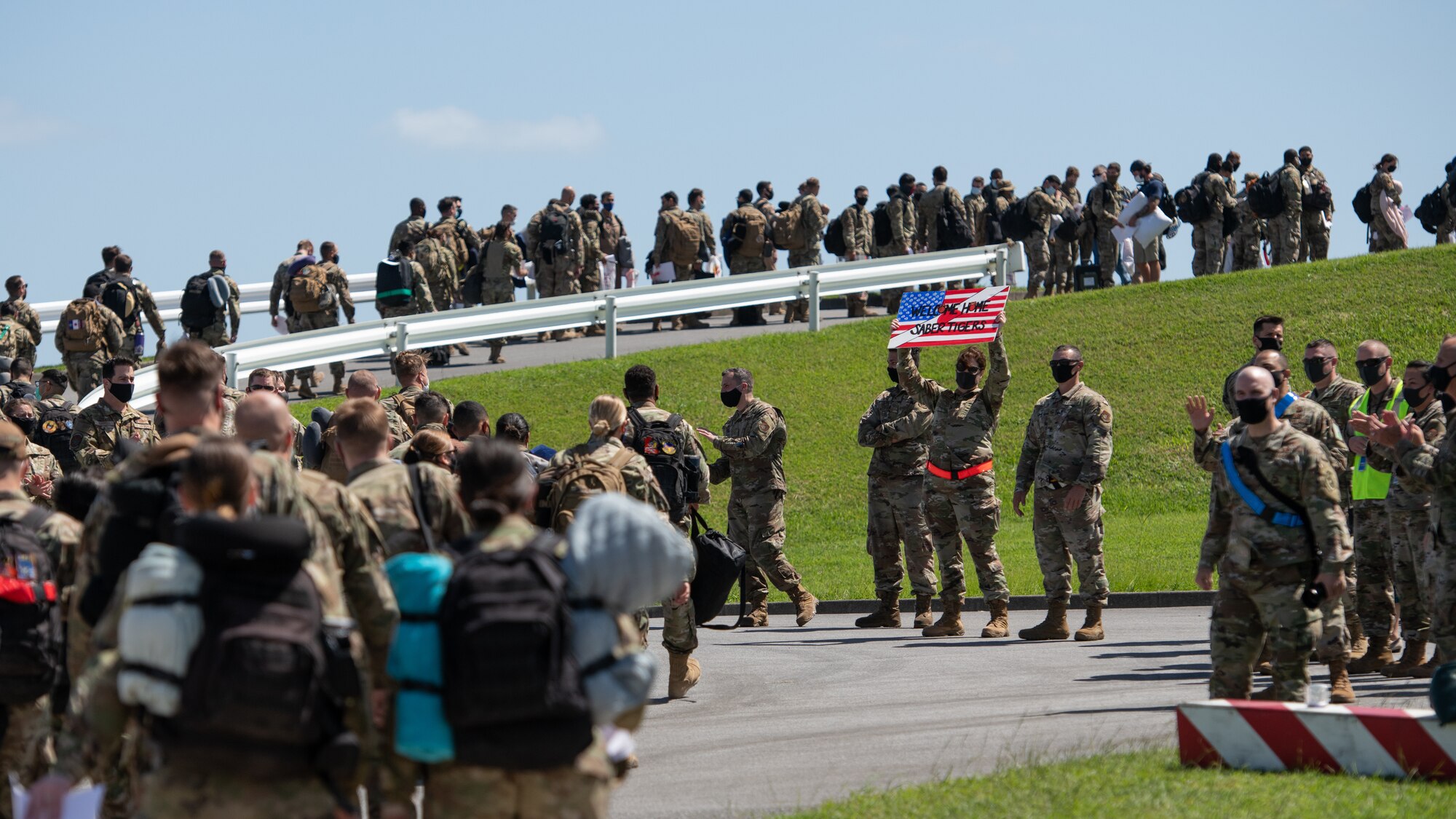 Members of the 18th Wing walk toward the air terminal at Kadena Air Base, Japan, after returning from a deployment to U.S. Central Command Oct. 6, 2020. More than 300 Airmen assigned to the 18th Operations and Maintenance Groups as well as pilots and aircraft assigned to the 44th Fighter Squadron deployed to the CENTCOM theater to defend U.S. and partner nation interests. During their deployment, Airmen conducted more than 1,000 sorties and 5,300 combat hours, which drove 13 phase inspections in six months. They’ll share the skills they learned in combat with Team Kadena, joint partners and allies to ensure a free and open Indo-Pacific. (U.S. Air Force photo by Staff Sgt. Peter Reft)