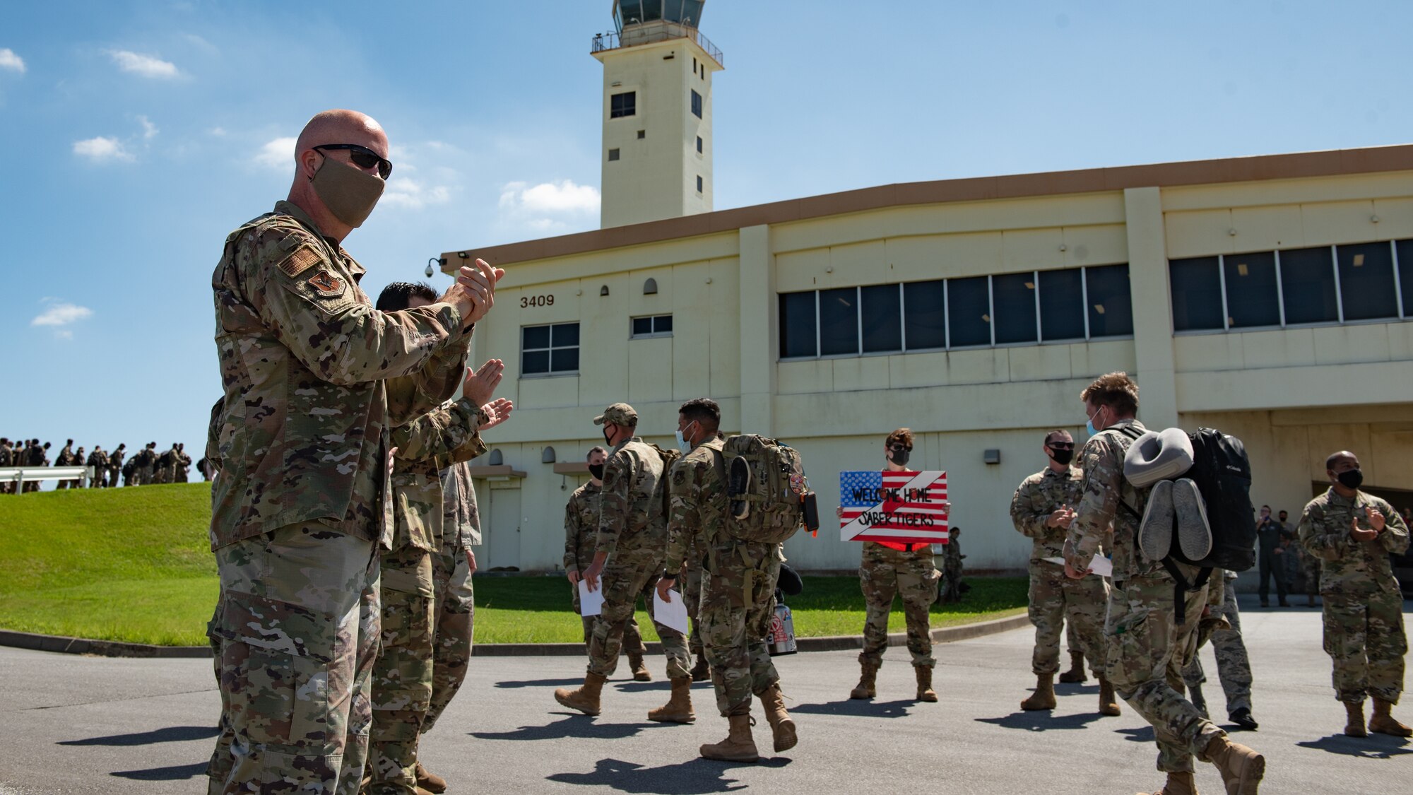 U.S. Air Force Brig. Gen. Joel L. Carey, 18th Wing commander, and other leaders welcome Airmen home from a deployment to U.S. Central Command Oct. 6, 2020, at Kadena Air Base, Japan. During their deployment, Airmen assigned to 18th Aircraft Maintenance Squadron, 18th Component Maintenance Squadron, 18th Equipment Maintenance Squadron, 18th Munitions Squadron, 18th Maintenance Operations Flight, and 18th Operations Support Squadron along with the 44th Fighter Squadron supported ongoing operations maintaining air superiority, defending forces on the ground, enhancing regional partnerships, and demonstrating a continued commitment to regional security and stability. (U.S. Air Force photo by Staff Sgt. Peter Reft)