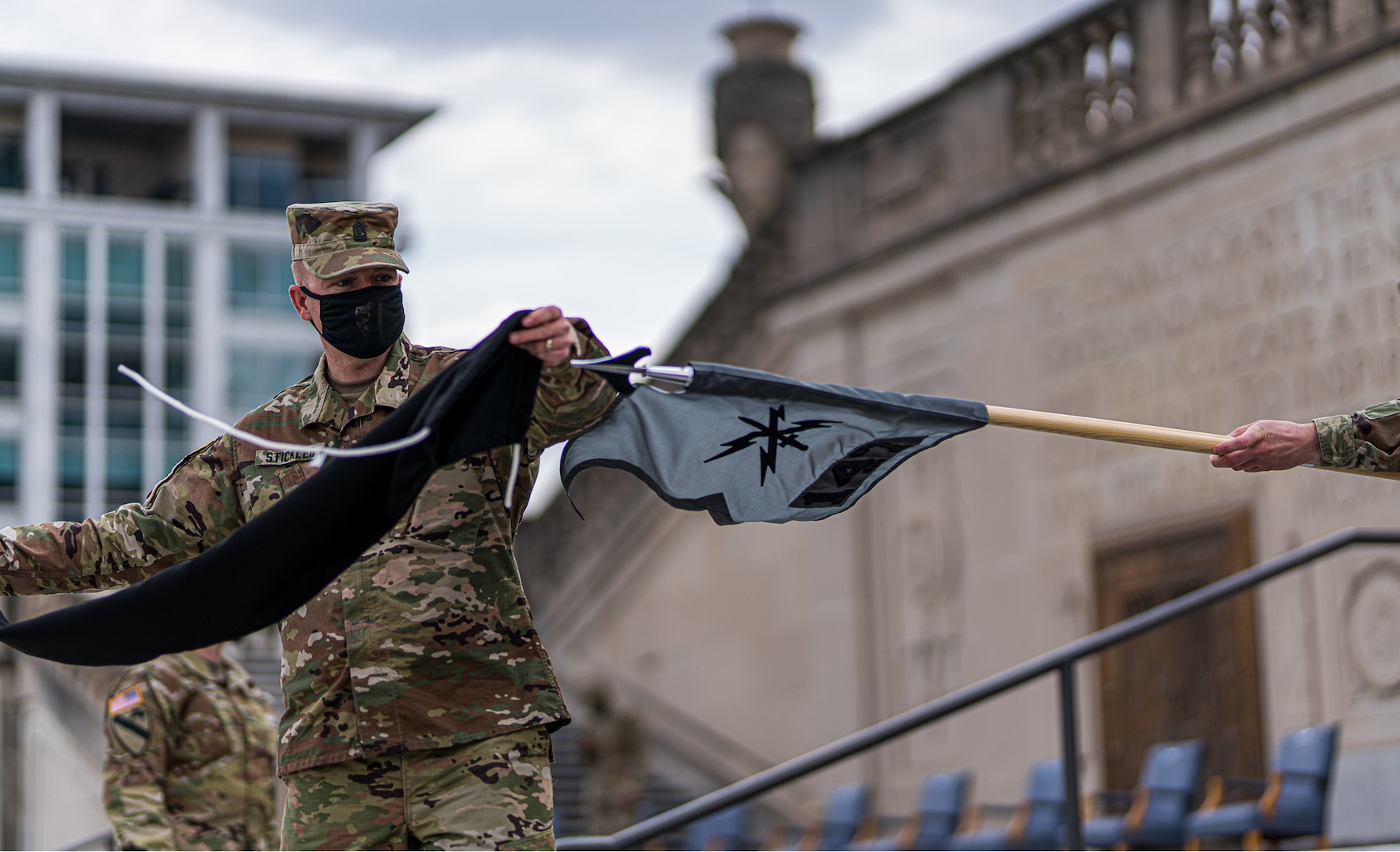 1st Sgt. John Stickler uncases one of Indiana National Guard’s new 127th Cyber Protection Battalion guidons at the Indiana War Memorial Oct. 3, 2020. The battalion of nearly 100 Citizen-Soldiers protects military networks and service members from internet-based and online attacks.
