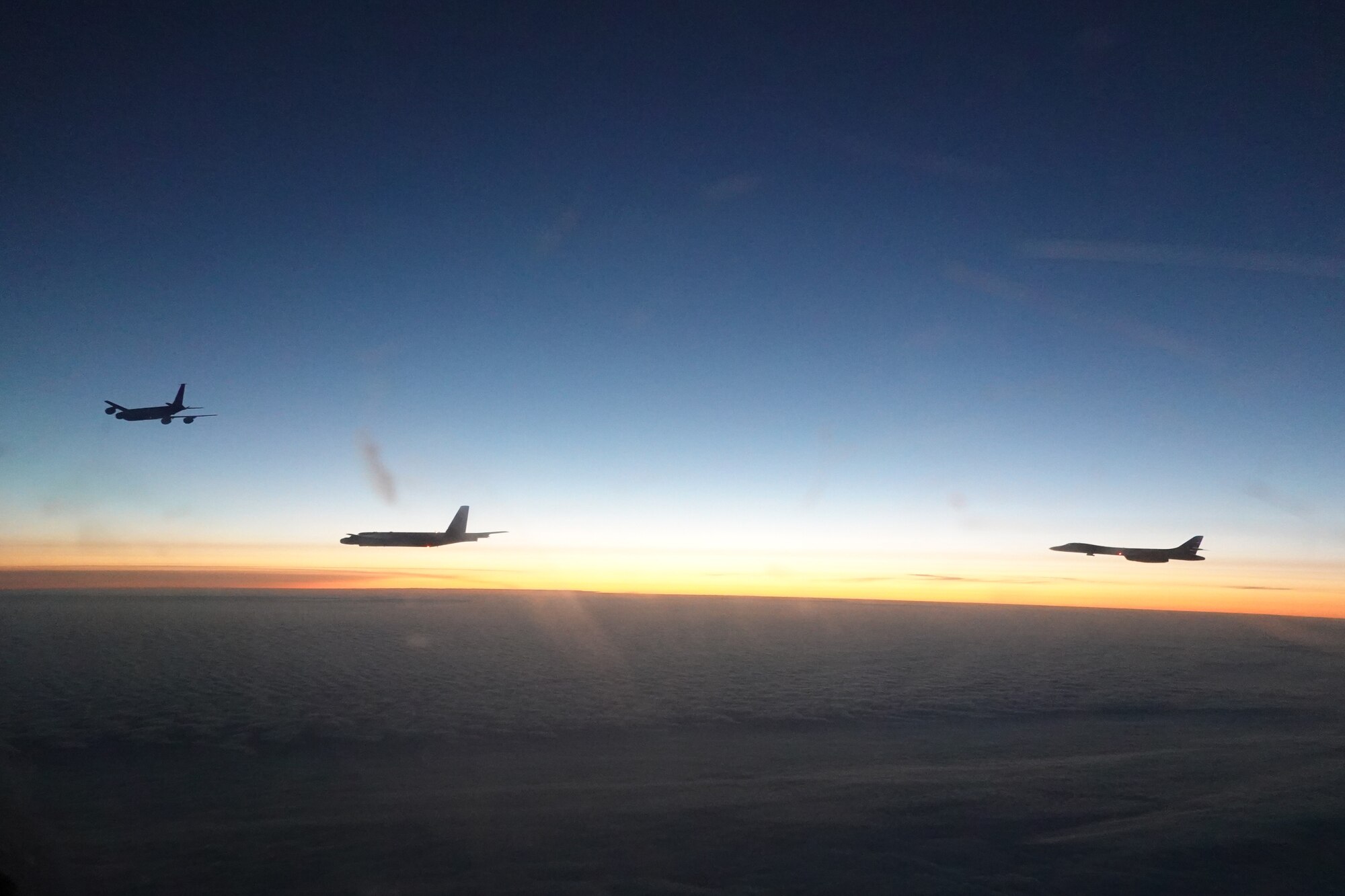 Photo of two bombers flying behind a tanker.