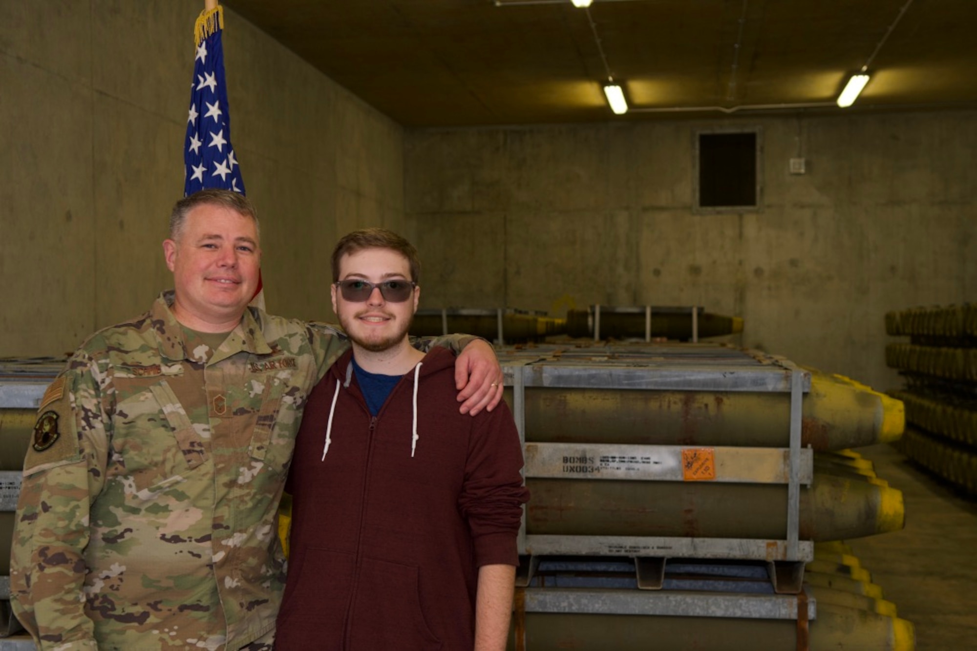 U.S. Air Force SMSgt Casey Schmid, left, 420th Munitions Squadron superintendent, along with his son Corey, pose for a photo following a Delayed Entry Program enlistment ceremony at RAF Welford, England, Sept. 28, 2020. Corey Schmid is the first person in over 65 years to enlist at RAF Welford into the Delayed Entry Program. (Courtesy Photo)