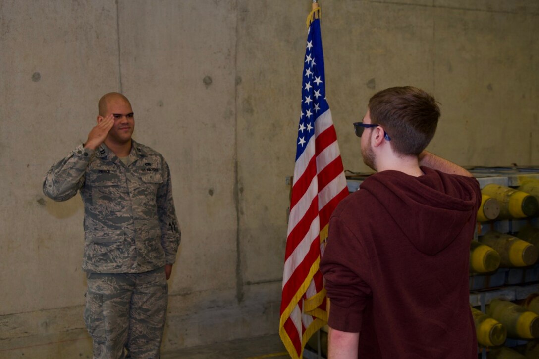 Corey Schmid, right, salutes U.S. Air Force Capt. Jordan Pierce, 420th Munitions Squadron munitions operations officer, after taking the oath of enlistment at RAF Welford, England, Sept. 28, 2020. Schmid is the first person in over 65 years to enlist at RAF Welford into the Delayed Entry Program. (Courtesy Photo)