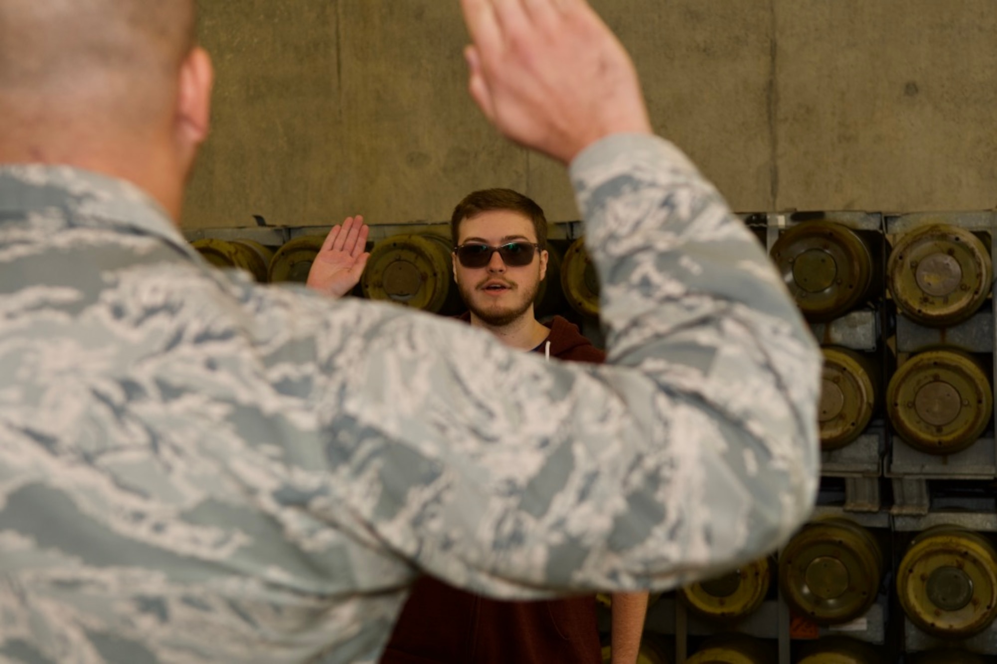 Corey Schmid takes the oath of enlistment from U.S. Air Force Capt. Jordan Pierce, 420th Munitions Squadron munitions operations officer at RAF Welford, England, Sep. 28, 2020. Schmid is the first person in over 65 years to enlist at RAF Welford into the Delayed Entry Program. (Courtesy Photo)