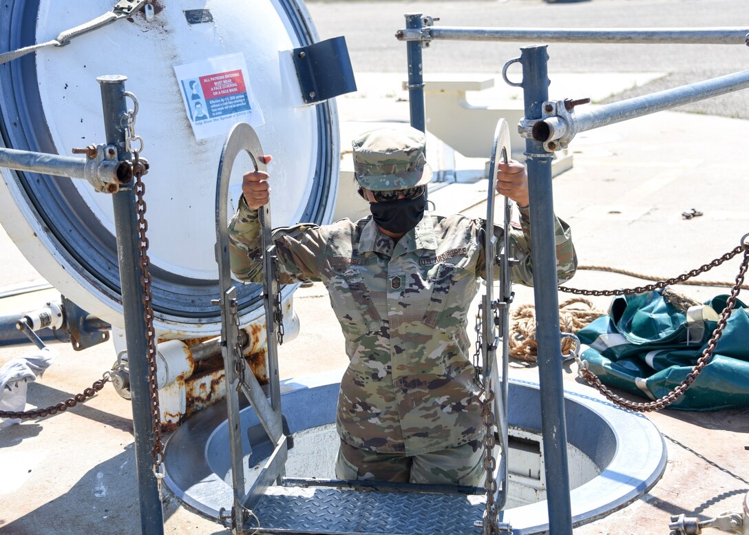 Chief Master Sgt. Diena Mosely, 82nd TRW command chief, climbs out of a missile silo
