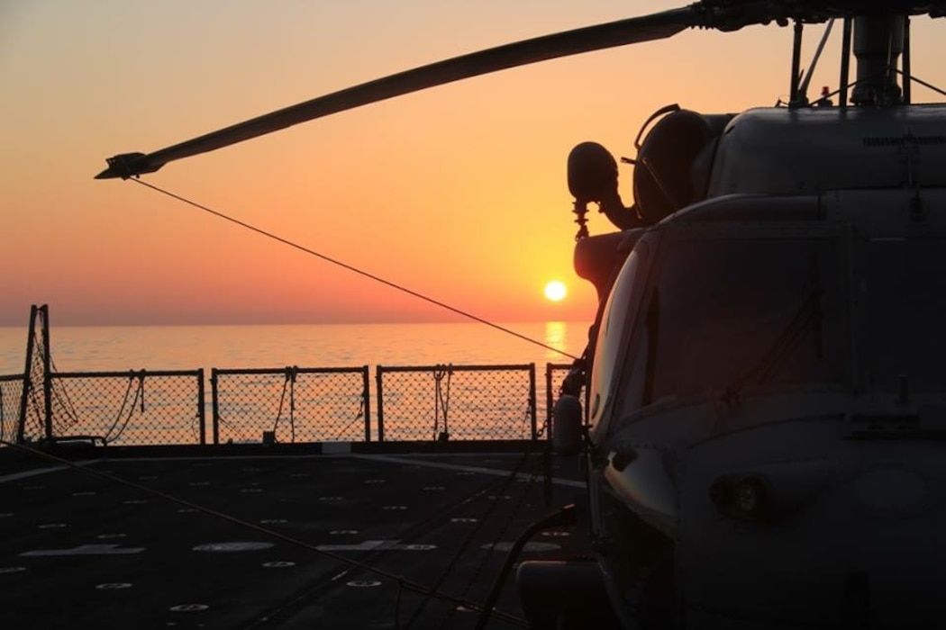 200930-N-IG620-0020. HSC-22 Helo during a sunset.