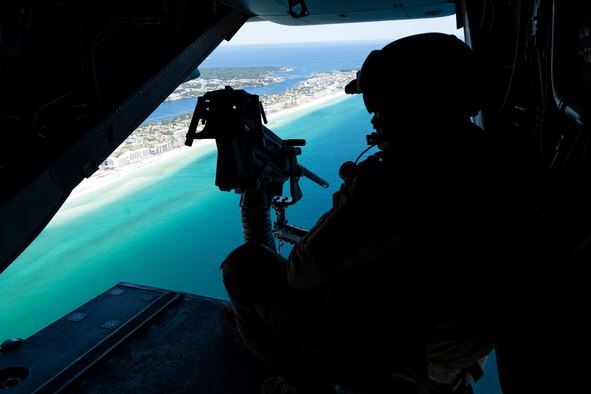 U.S. Air Force Staff Sgt. Tyler Cameron, a special missions aviator assigned to the 8th Special Operations Squadron, scans the horizon as a CV-22B Osprey tiltrotor aircraft flies above the Emerald Coast of Florida, Sept. 30, 2020. The Osprey combines the vertical takeoff, landing and hover capabilities of a helicopter with the long-range, fuel efficient and speed characteristics of a turboprop aircraft. (U.S. Air Force photo by Staff Sgt. Joseph Pick)