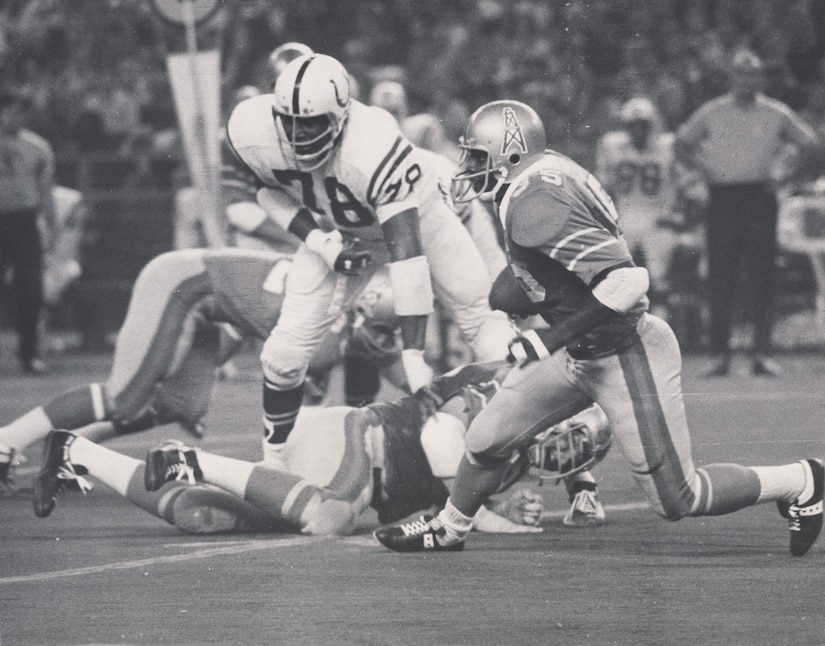 A photo shows football players on the field during a game.