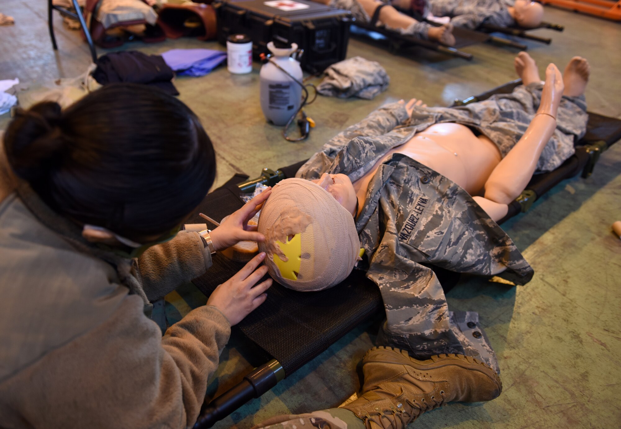 Tech. Sgt. Angela Kim, emergency medical service program manager at the 48th Medical Group, prepares a medical simulation manikin for Mission Assurance Exercise 20-20 at Royal Air Force Feltwell, England, Sept. 29, 2020. During the exercise, medical personnel received unique training and challenged their proficiency, practicing medical skills and procedures while treating simulated injuries in a forward operating location. (U.S. Air Force photo by Airman 1st Class Rhonda Smith)