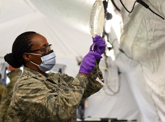 Maj. Stacey Walker assigned to the 48th Medical Operation Squadron, prepares an IV solution bag during Mission Assurance Exercise 20-20 at Royal Air Force Feltwell, England, Sept. 29, 2020. During the exercise, medical personnel received unique training and challenged their proficiency, practicing medical skills and procedures while treating simulated injuries in a forward operating location. (U.S. Air Force photo by Airman 1st Class Rhonda Smith)