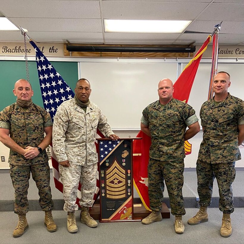 Sergeant Major Jabari Patton is congratulated during his retirement ceremony day by Sergeant Major Callahan, Sergeant Major Lopez, and Sergeant Major Reed on Marine Corps Base Cam Pendleton Calif. May 19,2020.