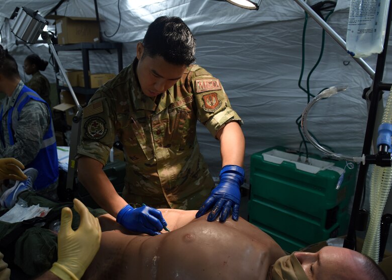 Maj. Christopher Ng, assigned to the 48th Surgical Services Squadron, performs a simulated surgery during Mission Assurance Exercise 20-20 at Royal Air Force Feltwell, England, Sept. 29, 2020. During the exercise, medical personnel received unique training and challenged their proficiency, practicing medical skills and procedures while treating simulated injuries in a forward operating location. (U.S. Air Force photo by Airman 1st Class Rhonda Smith)