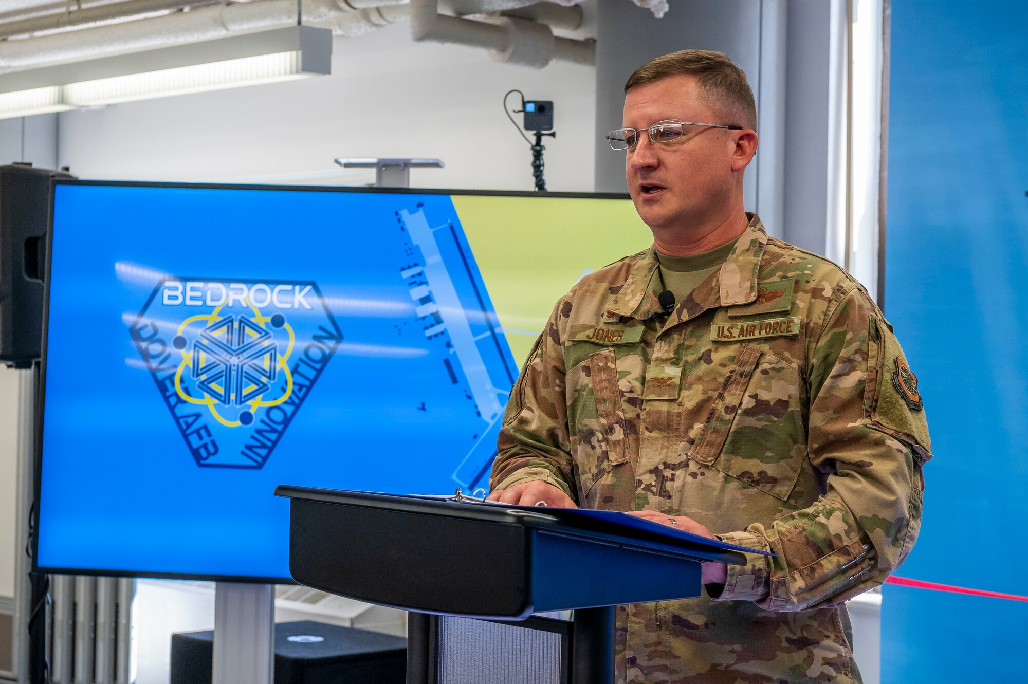 Col. Mathew Jones, 436th Airlift Wing commander, speaks during the ribbon-cutting ceremony at the new Bedrock facility, Sept. 23, 2020, at Dover Air Force Base, Delaware. Established in 2019, Bedrock’s goal is empowering Airmen to develop ideas and leverage new technologies to support the warfighter at home station or downrange. Bedrock’s new facility boasts over 5,000 square feet, housing large collaborative workspaces, an event stage, a virtual reality classroom, a podcast studio and a prototyping lab with 3D-printers. (U.S. Air Force photo by Senior Airman Christopher Quail)