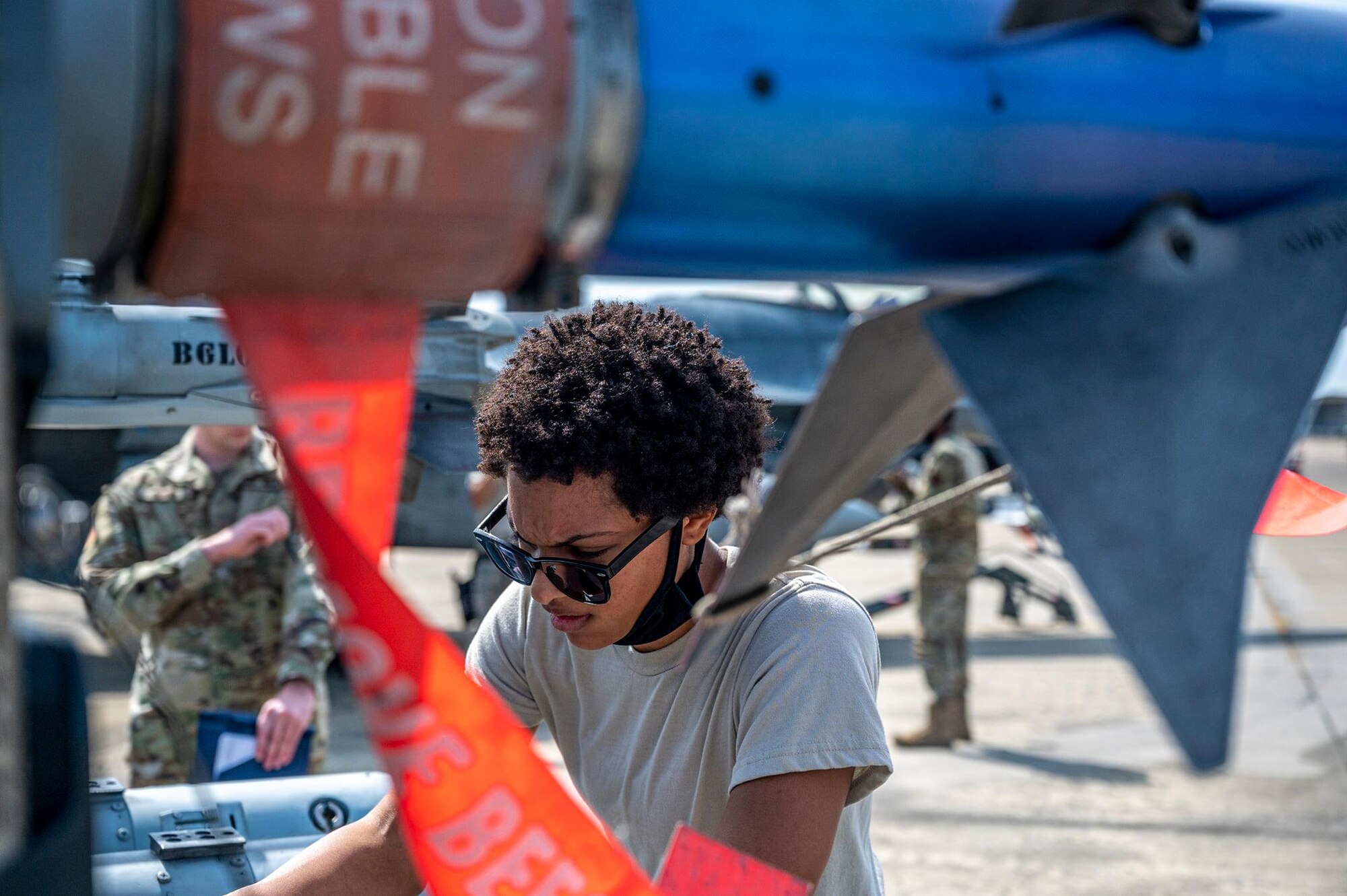 An Airman inspects munitions during a load crew competition.