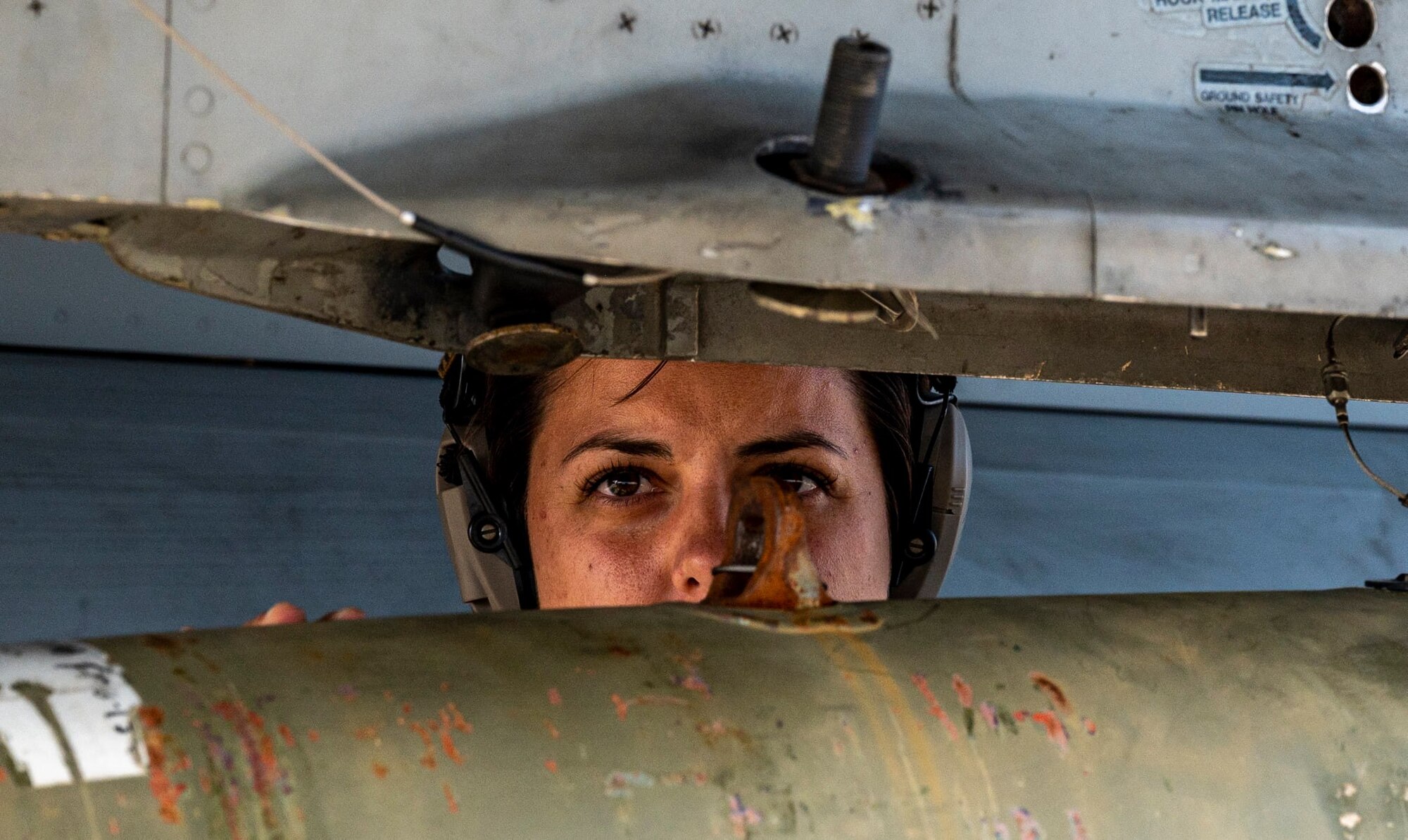 An Airman looks over a munition.